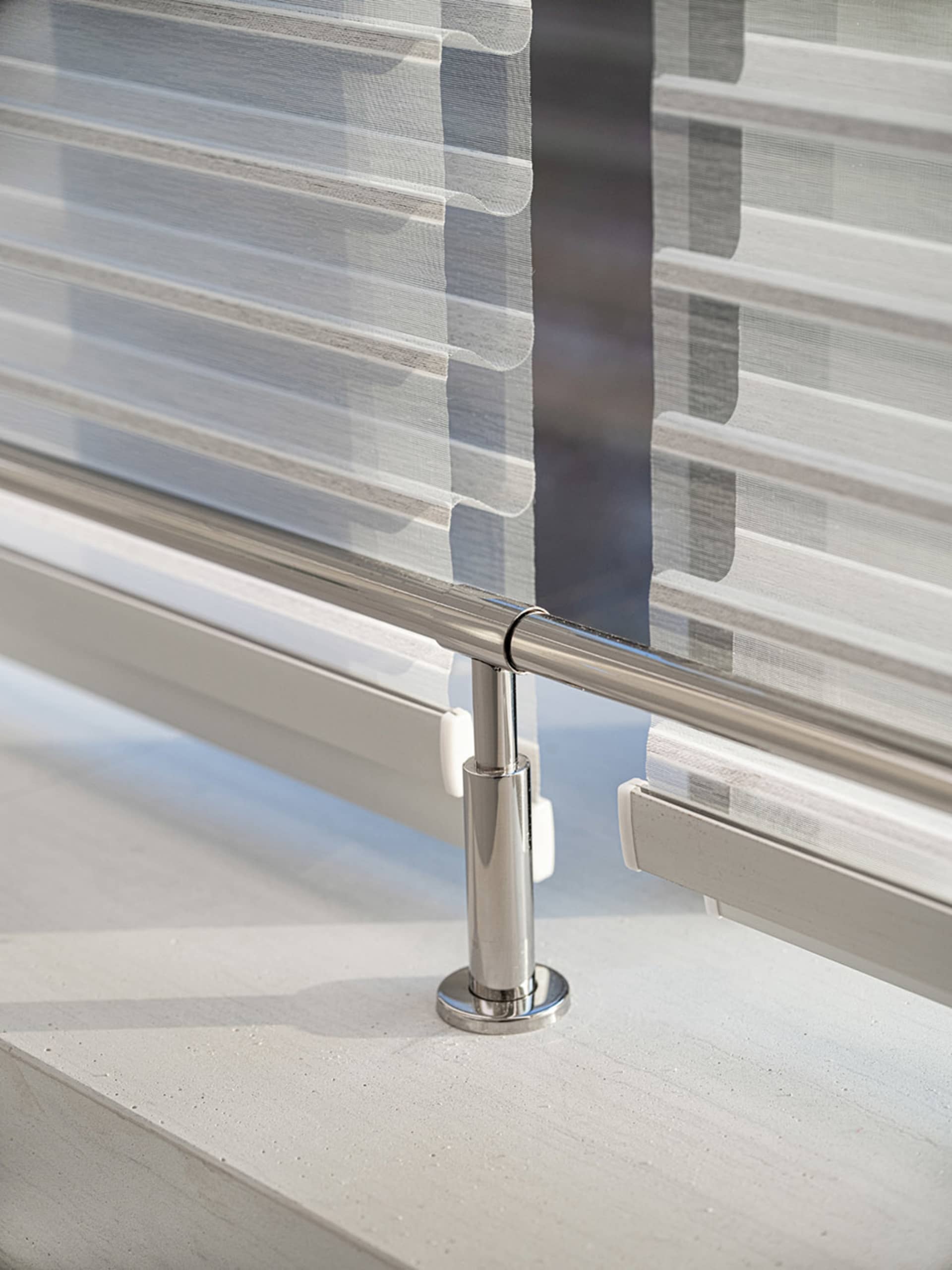 Modern minimalist design featuring metal railings on a concrete floor.