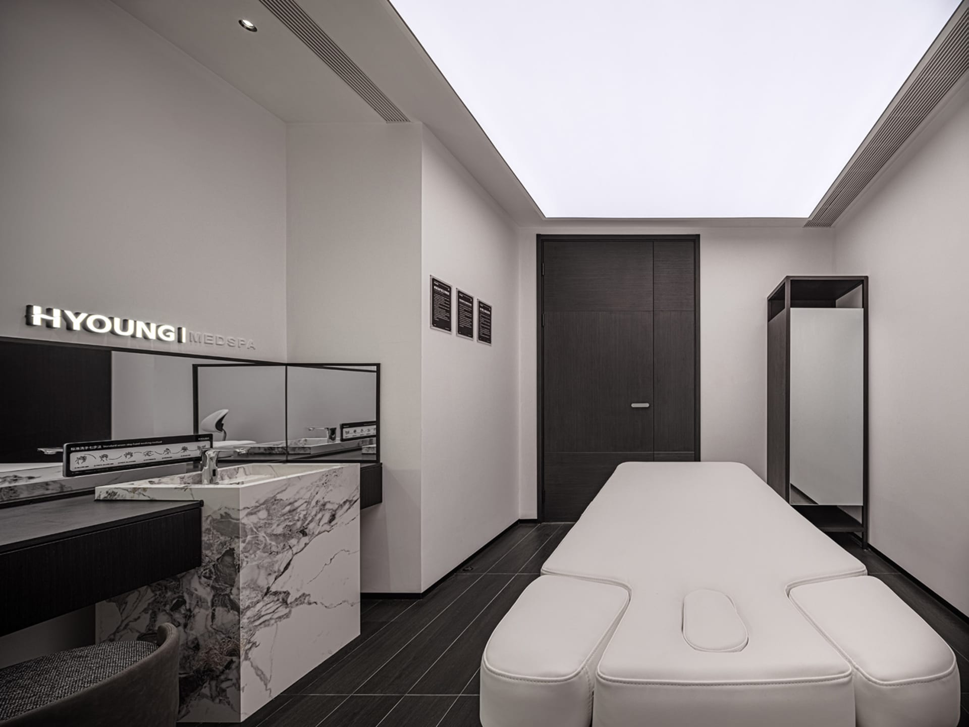 Modern interior design of a medi-spa featuring marble countertops and minimalist furniture.