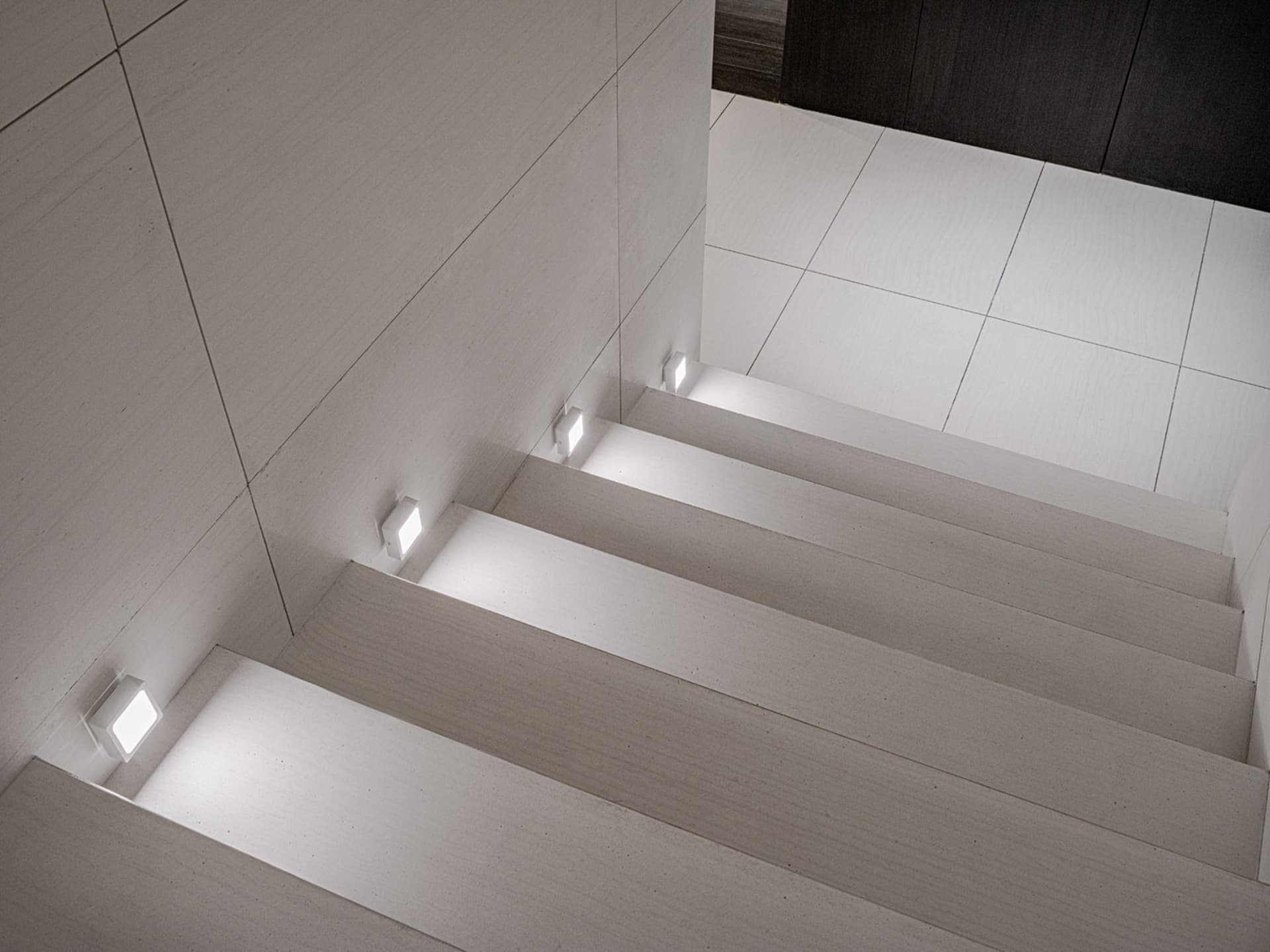 Modern staircase with LED lighting built into the steps and walls.