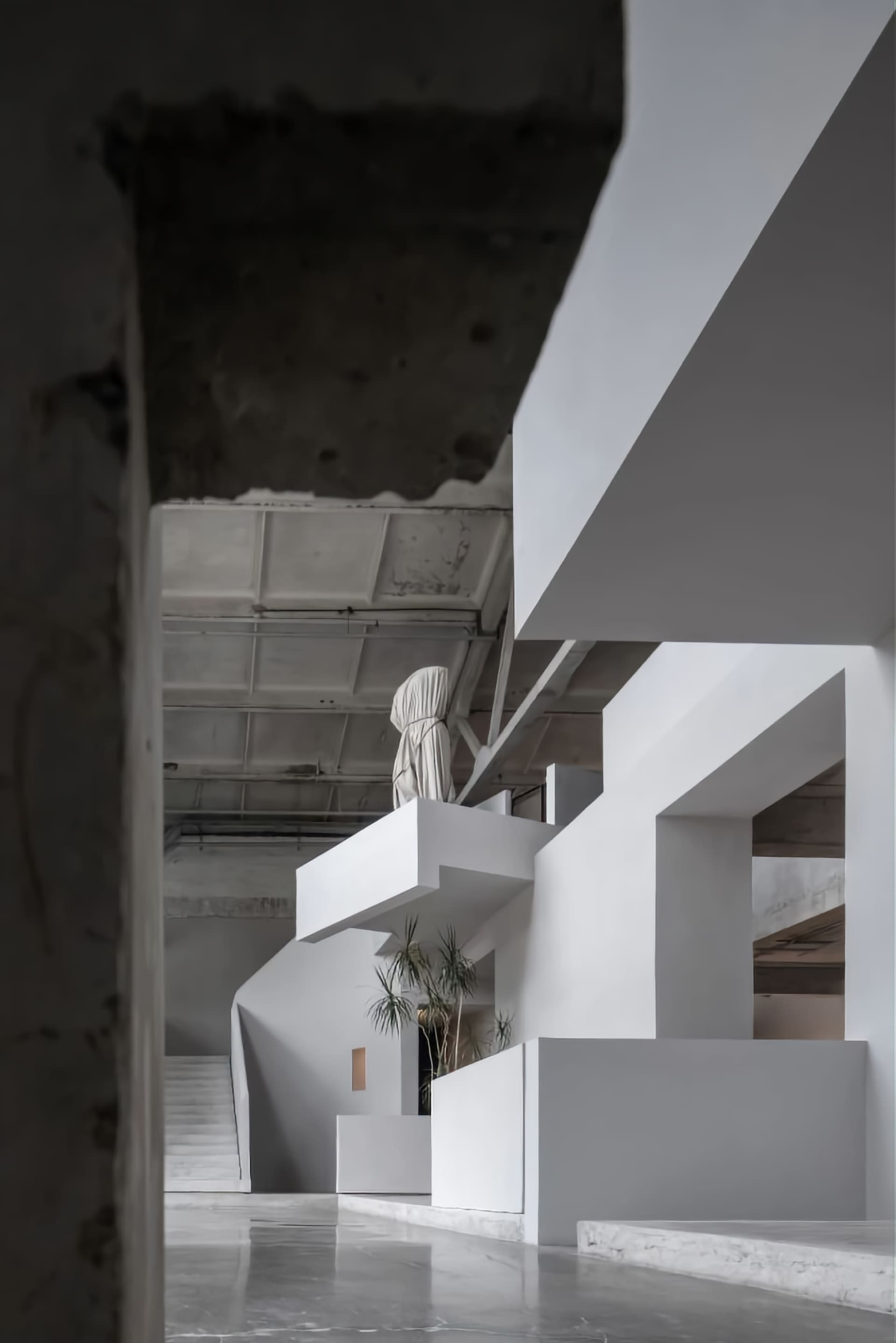 A white concrete staircase with modern design features in an interior space.
