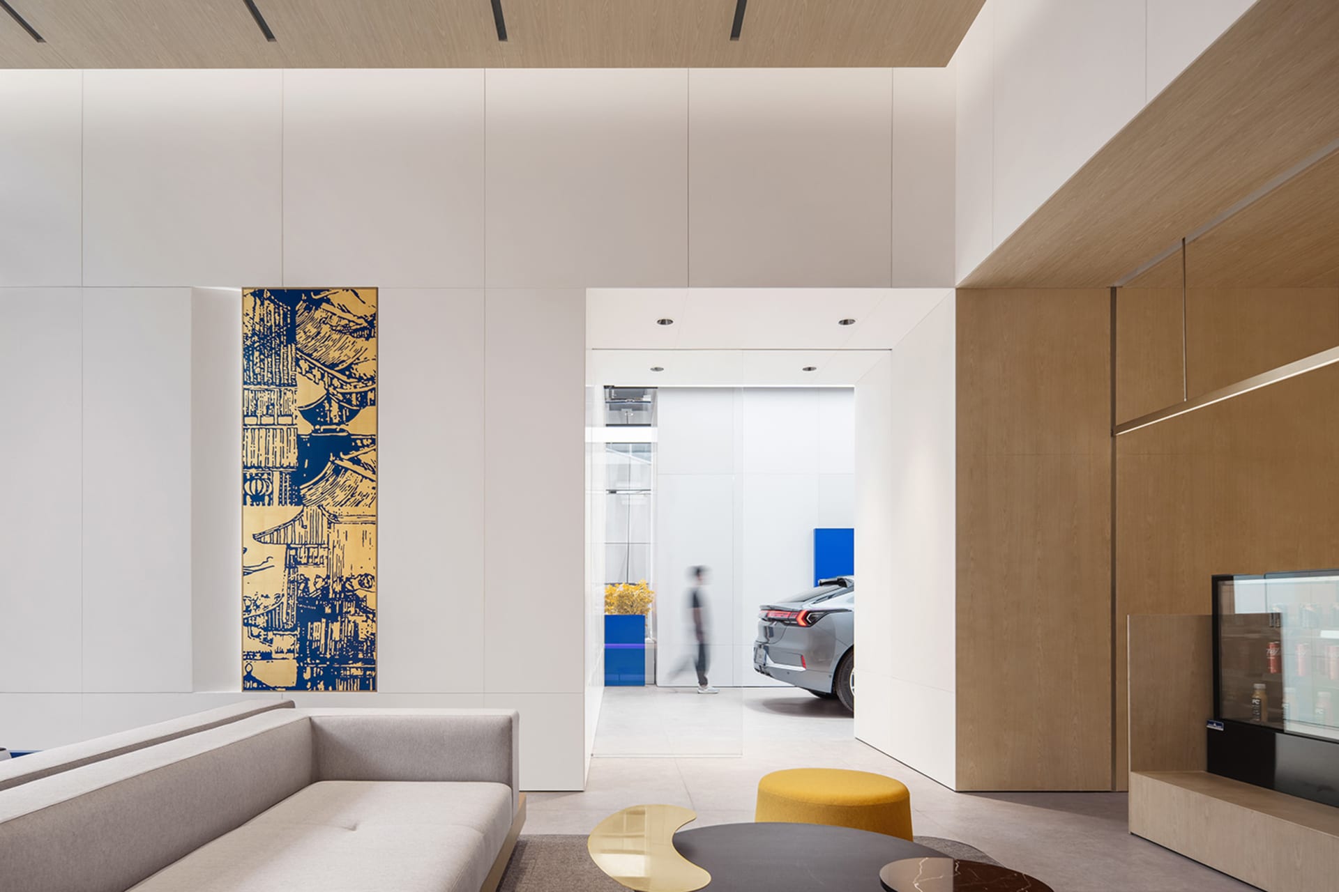A modern interior space featuring a living room with concrete, wood, and glass materials.