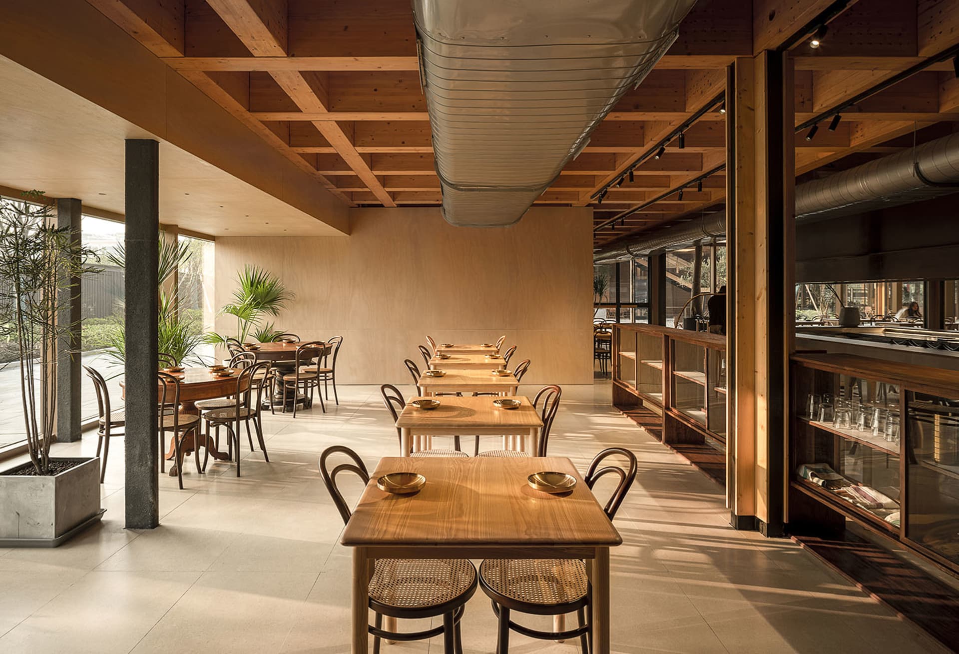 A modern restaurant interior featuring sustainable wood and glass materials.