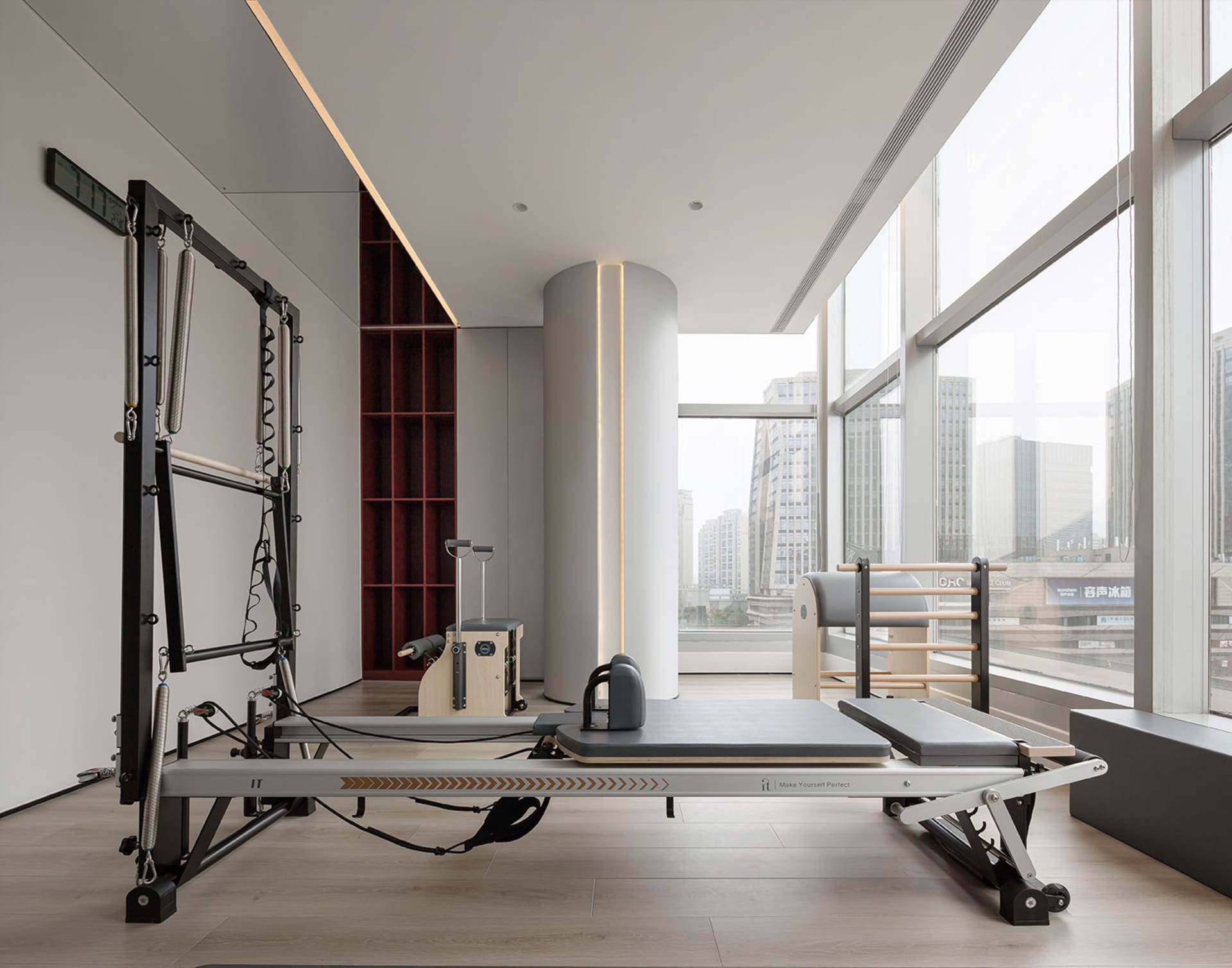 A spacious modern fitness center with glass walls。