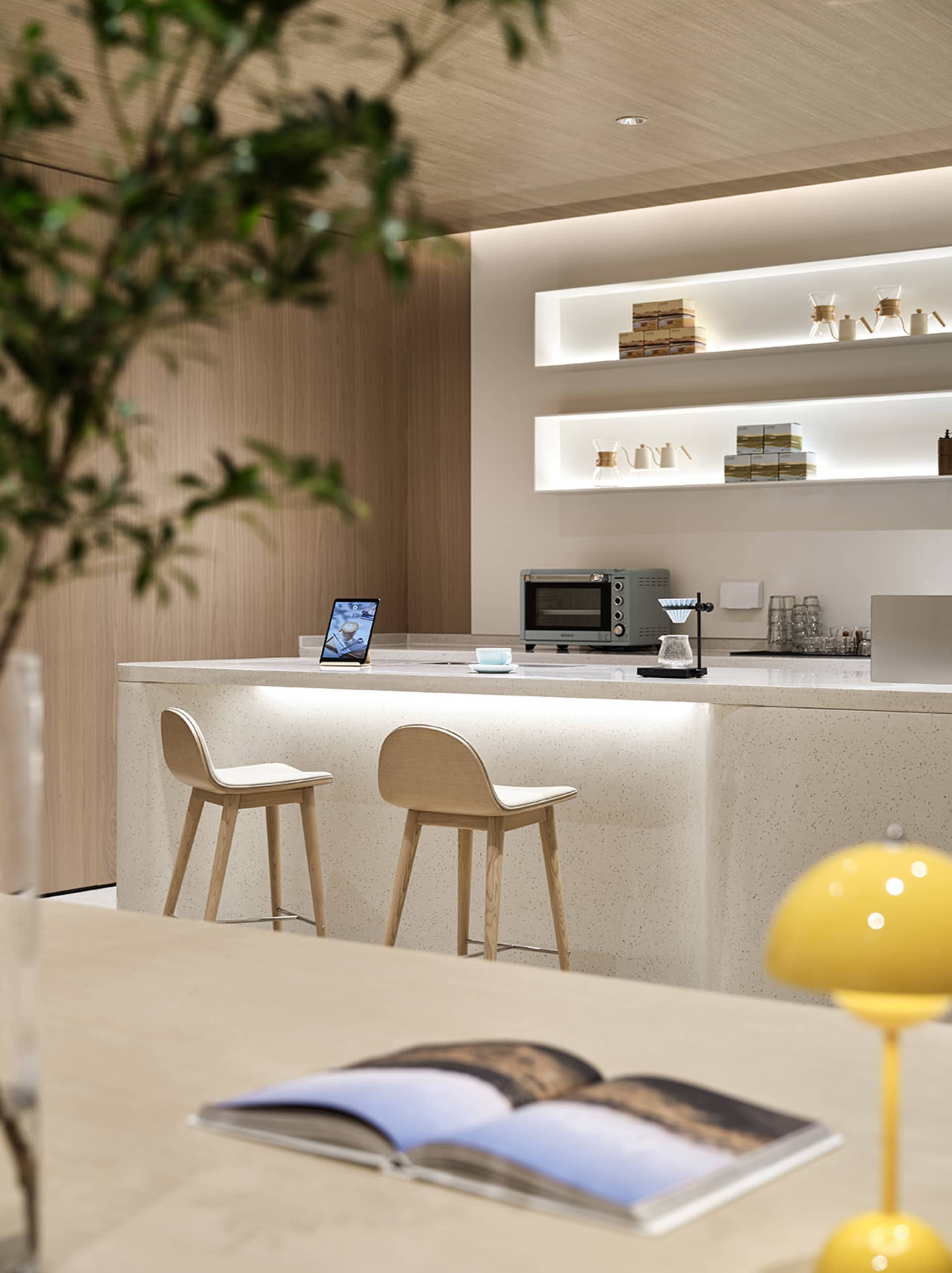 Modern design coffee shop featuring a terrazzo countertop and stools.