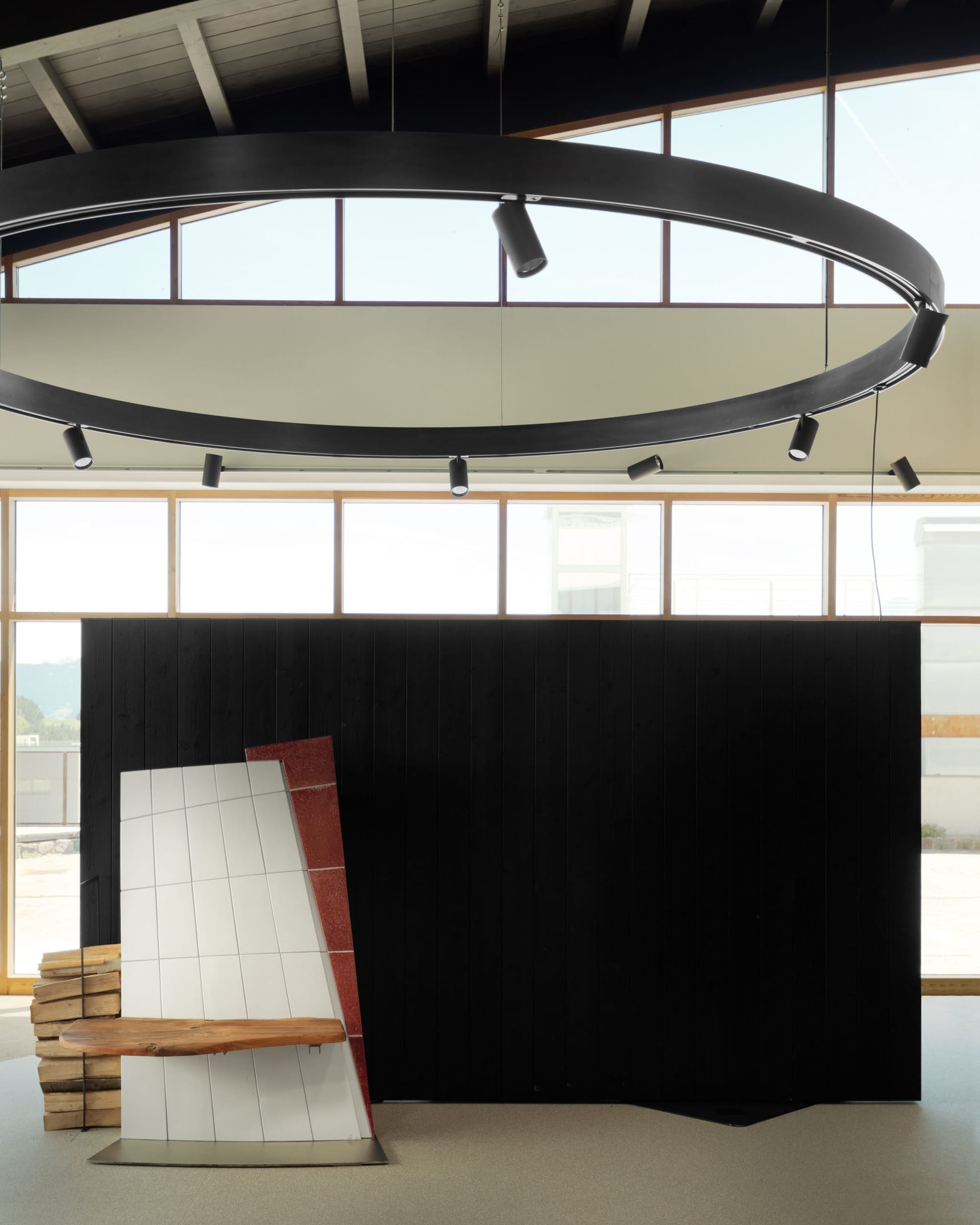 An industrial-style installation featuring black and red metallic elements and wooden details.