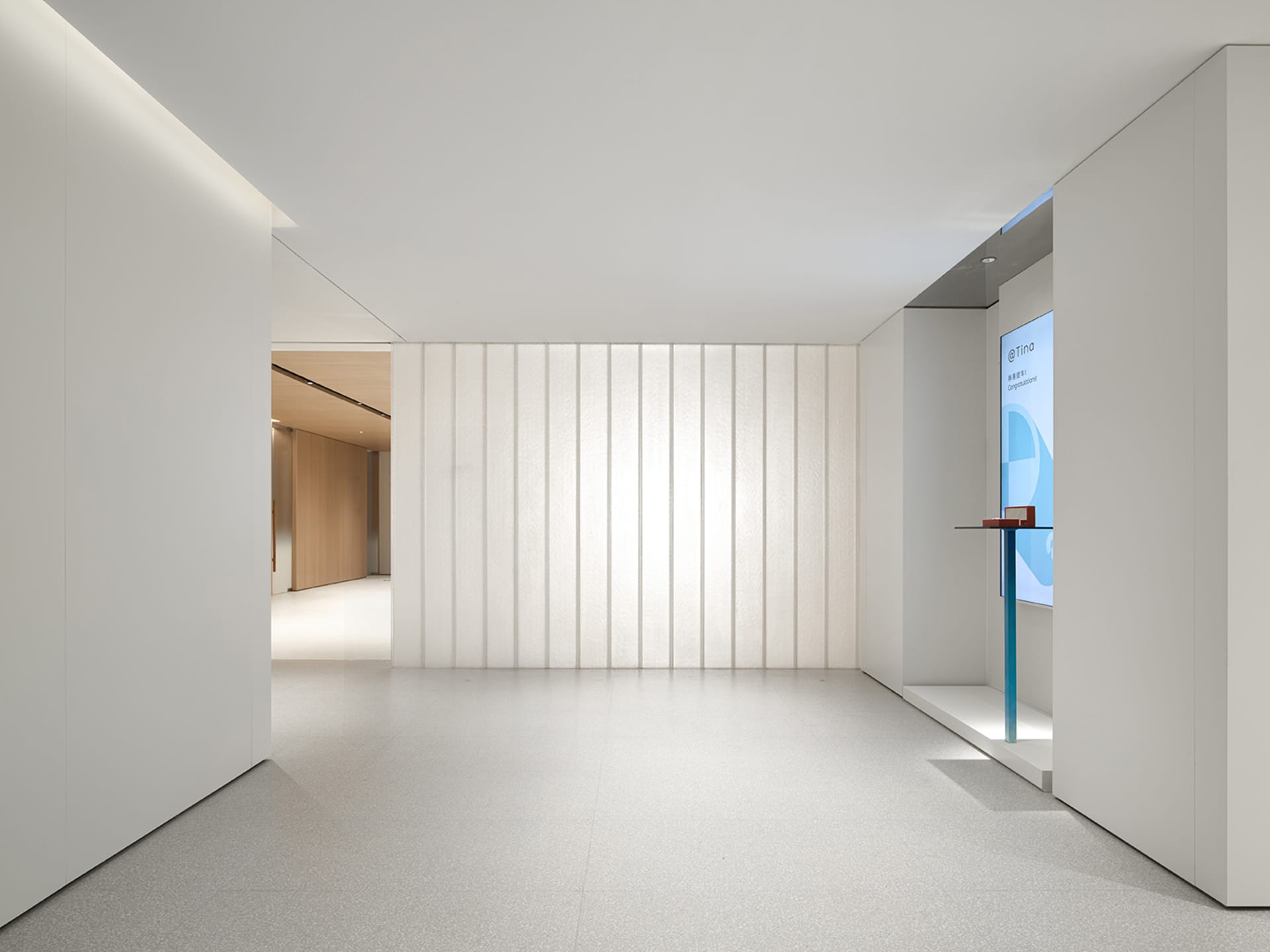 A minimalist office space featuring glass walls.