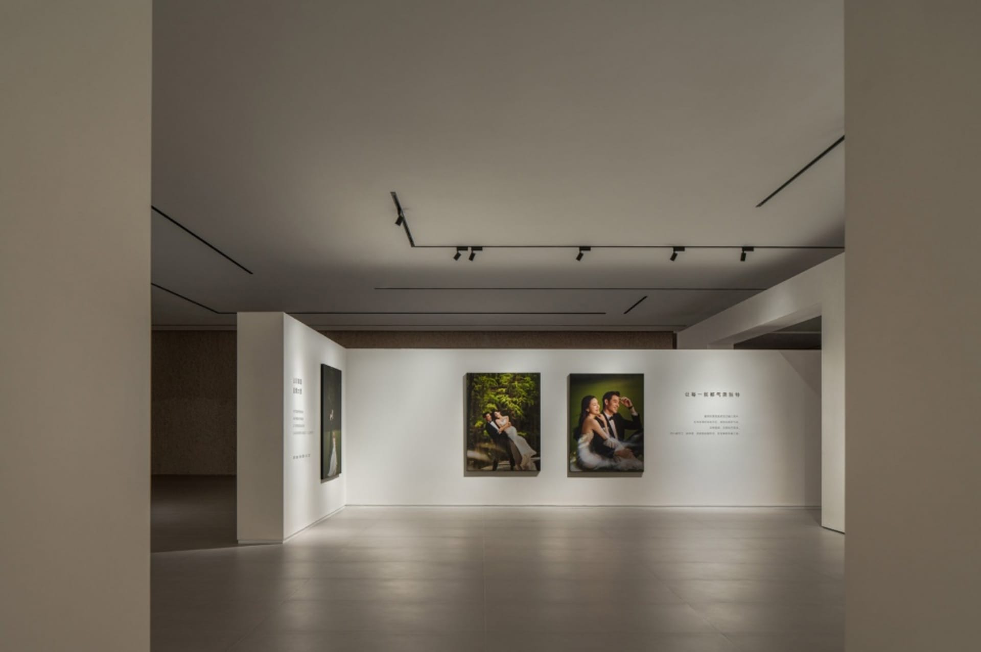 Photography exhibition in a modern space with white walls and minimalistic design.