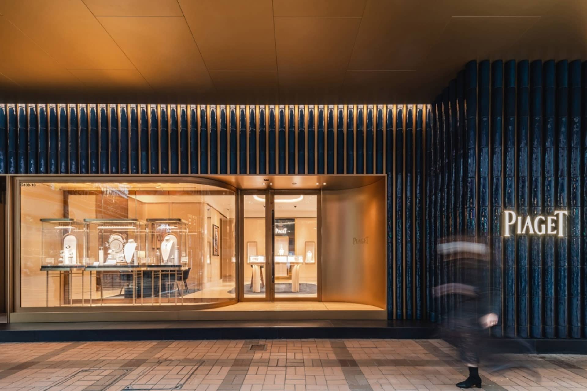 An elegant, modern storefront with glass windows and concrete elements.