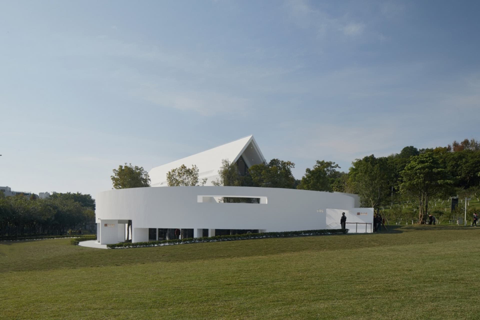 Modern building with white stone and concrete exterior.