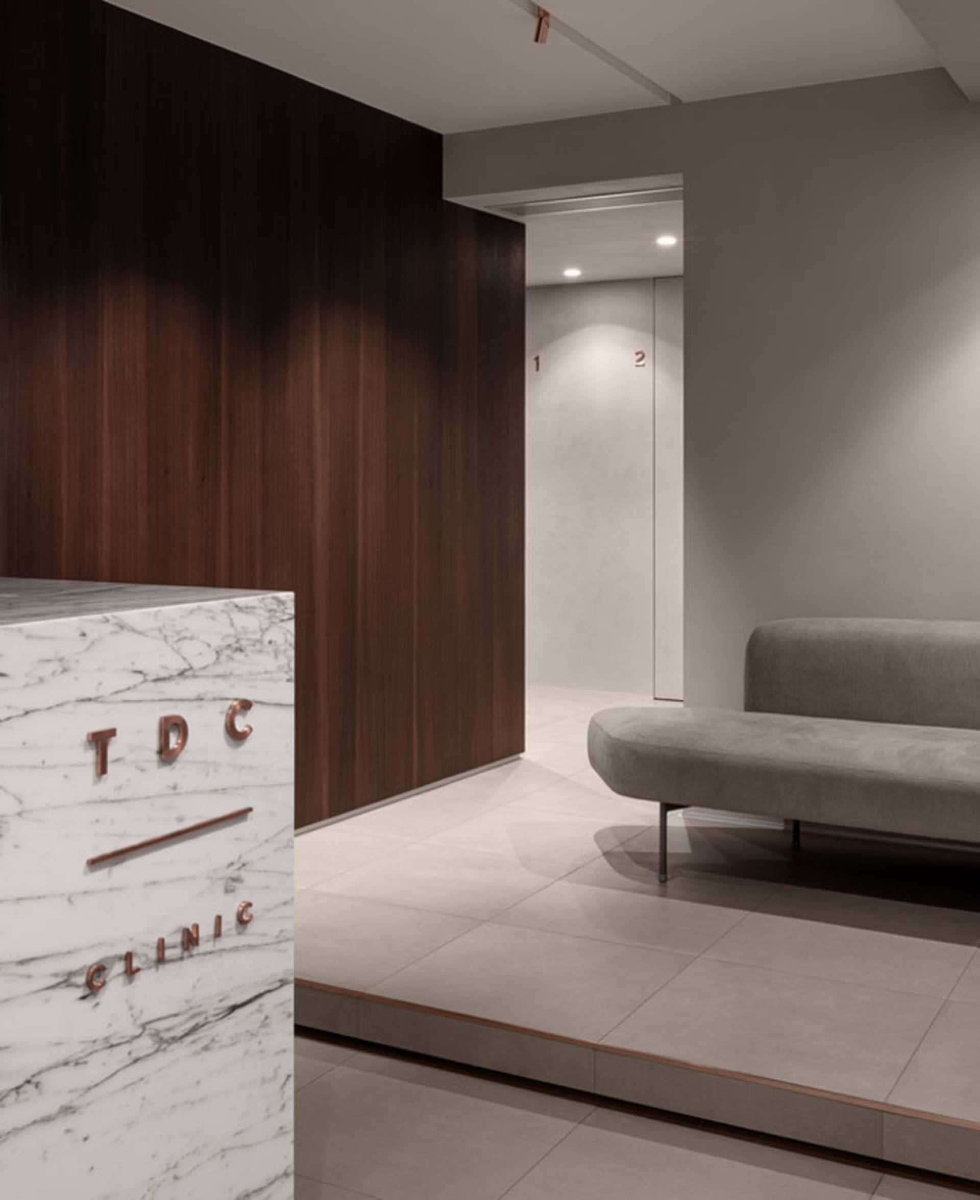 Modern hospitality interior design featuring marble, wood, and concrete materials.