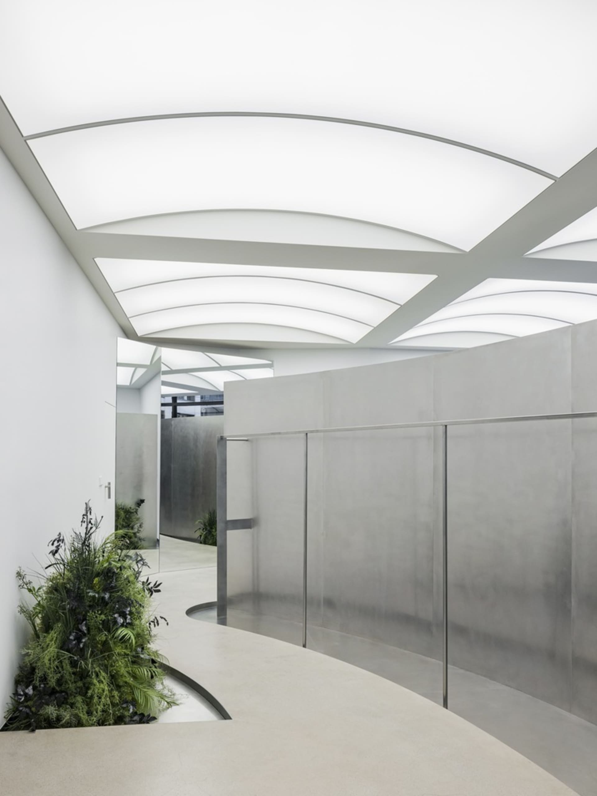 Modern interior featuring glass walls and concrete floors.