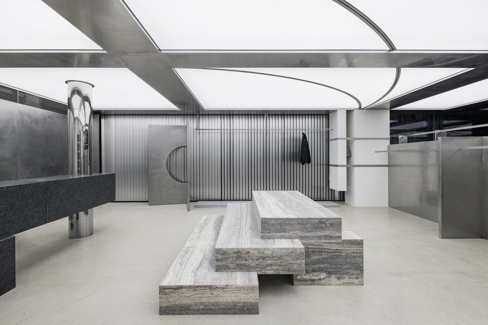 Industrial-style retail storefront with metal elements and concrete floor.