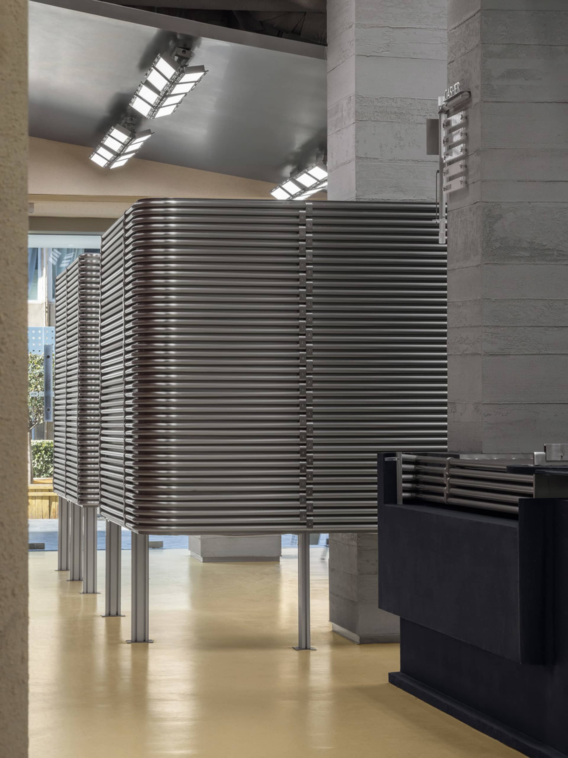 A modern lobby featuring a metallic grid structure.
