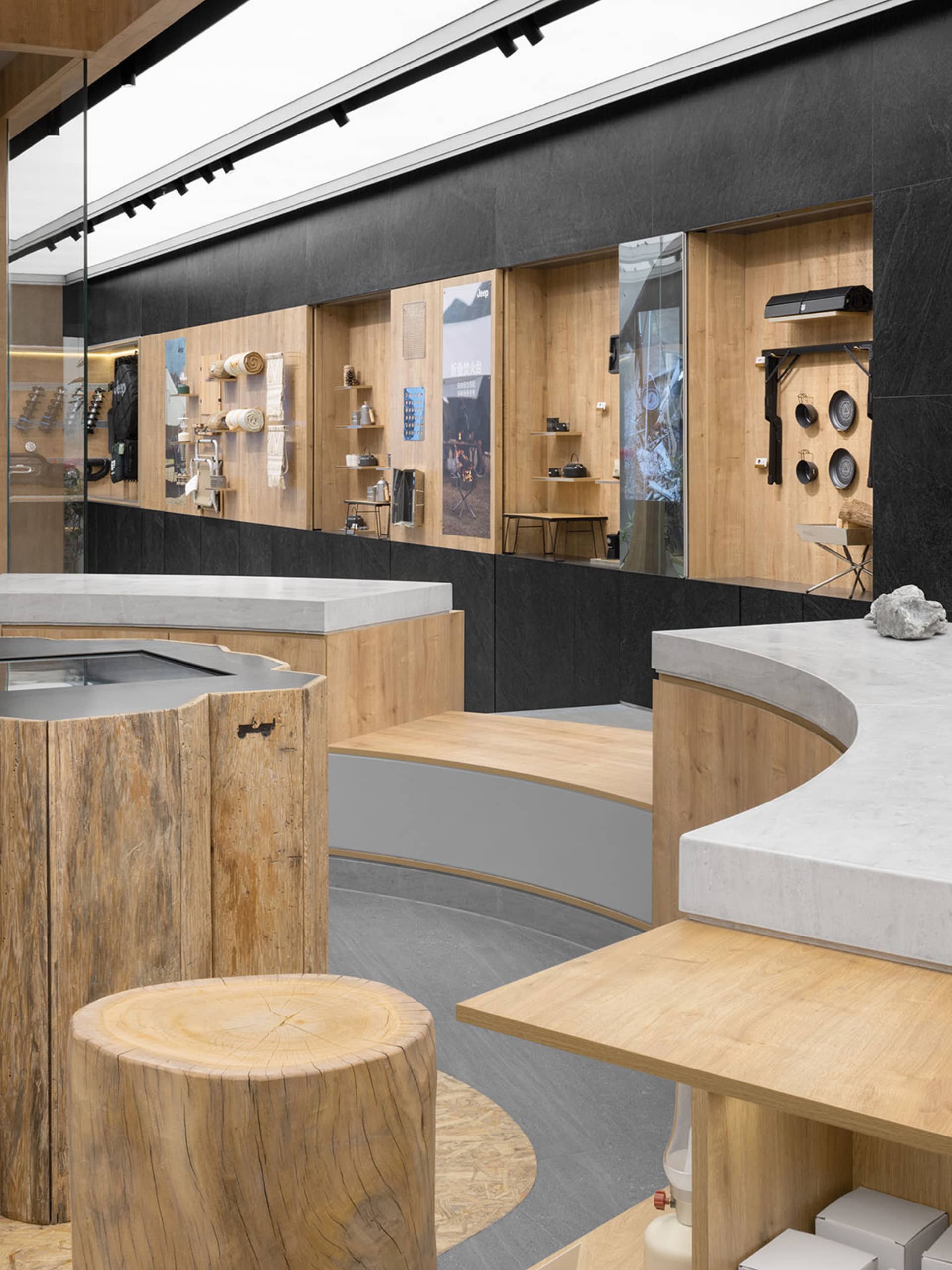 A modern retail display featuring wooden shelves and concrete countertops.