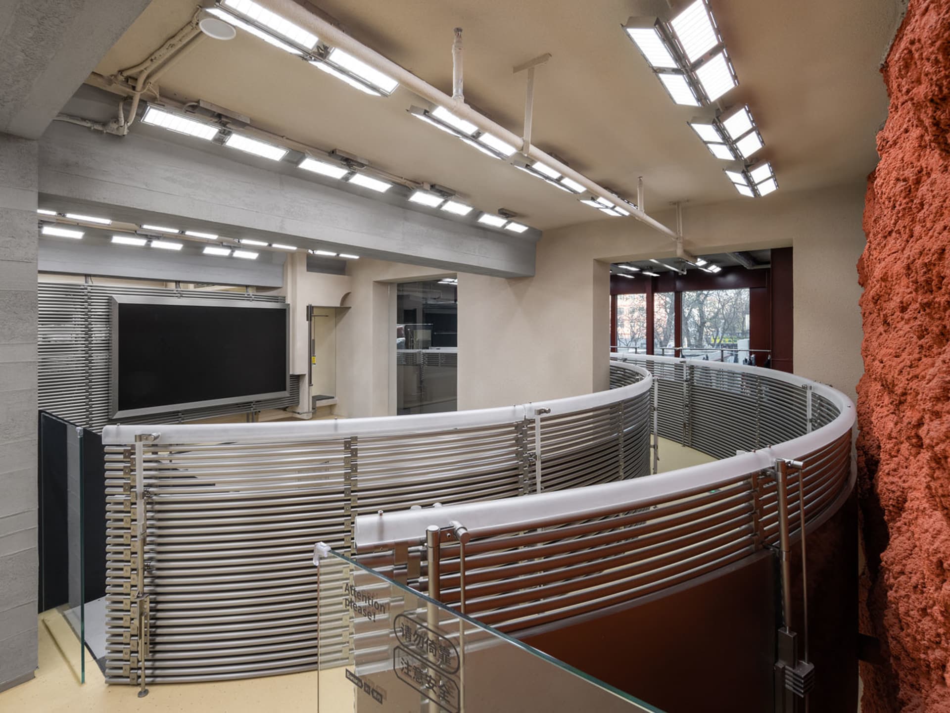An industrial exhibition hall featuring metallic structures and lighting.