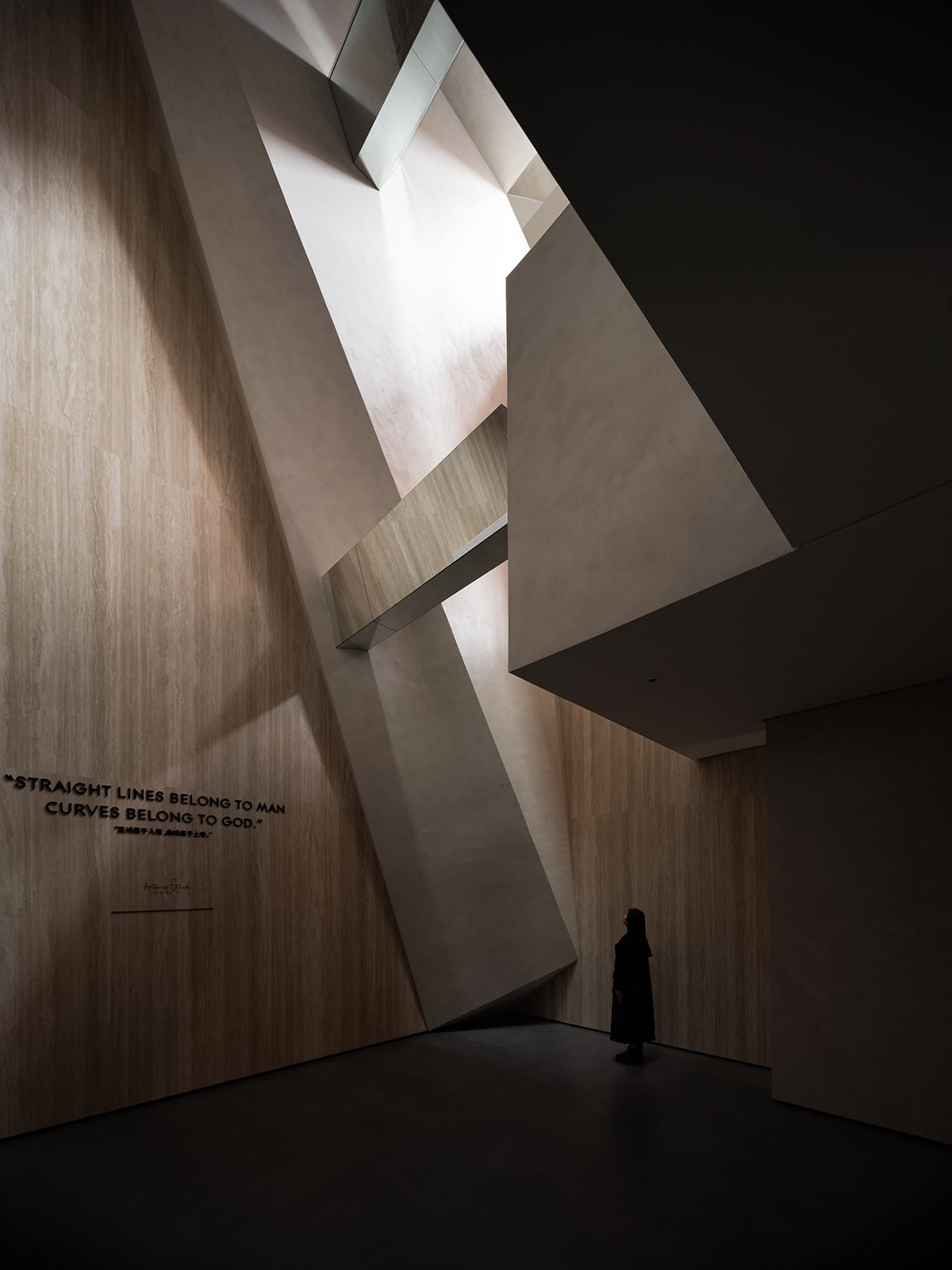 A modern architectural interior with a contemporary design featuring concrete elements and natural light.