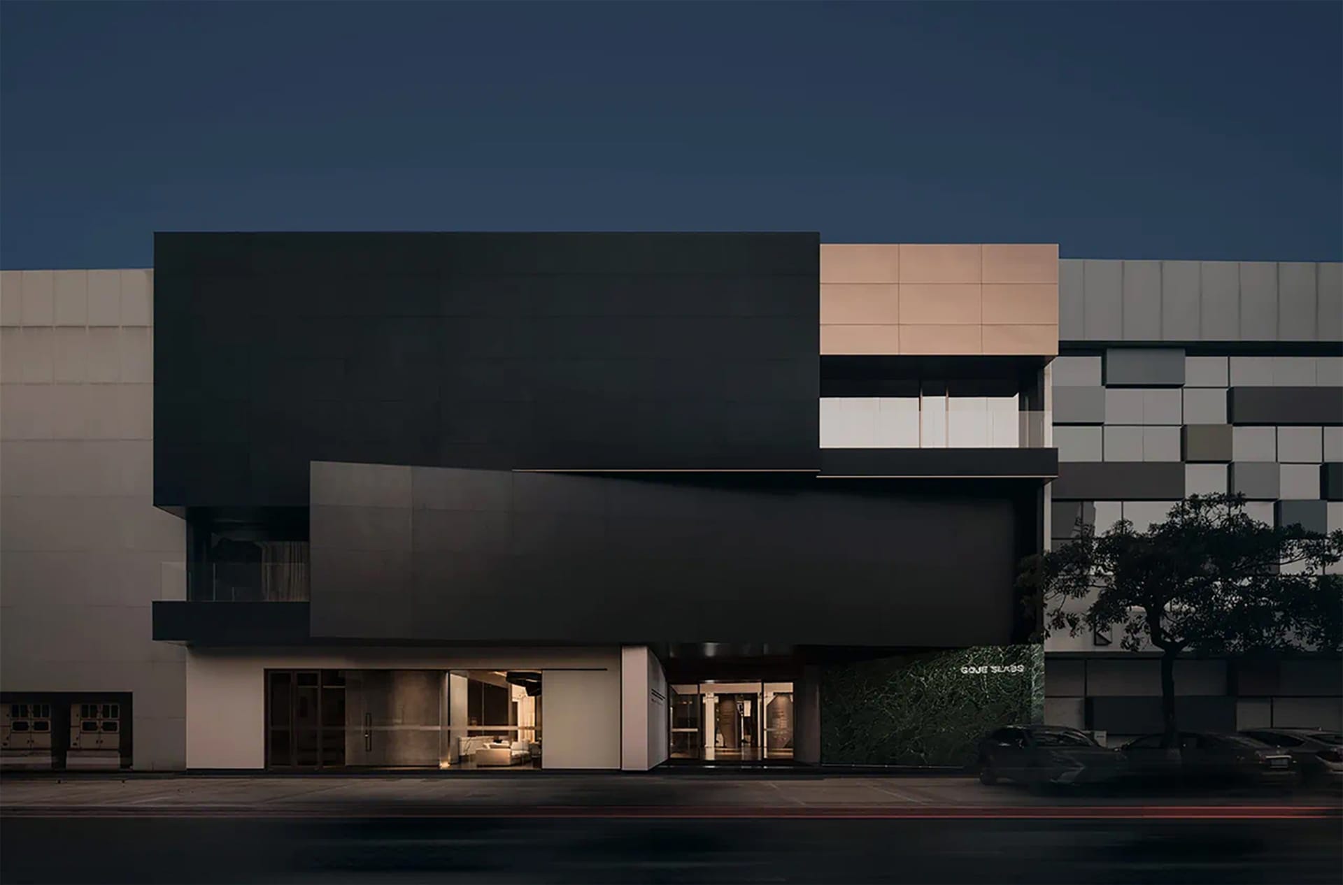A modern retail space featuring glass and concrete materials on the exterior.
