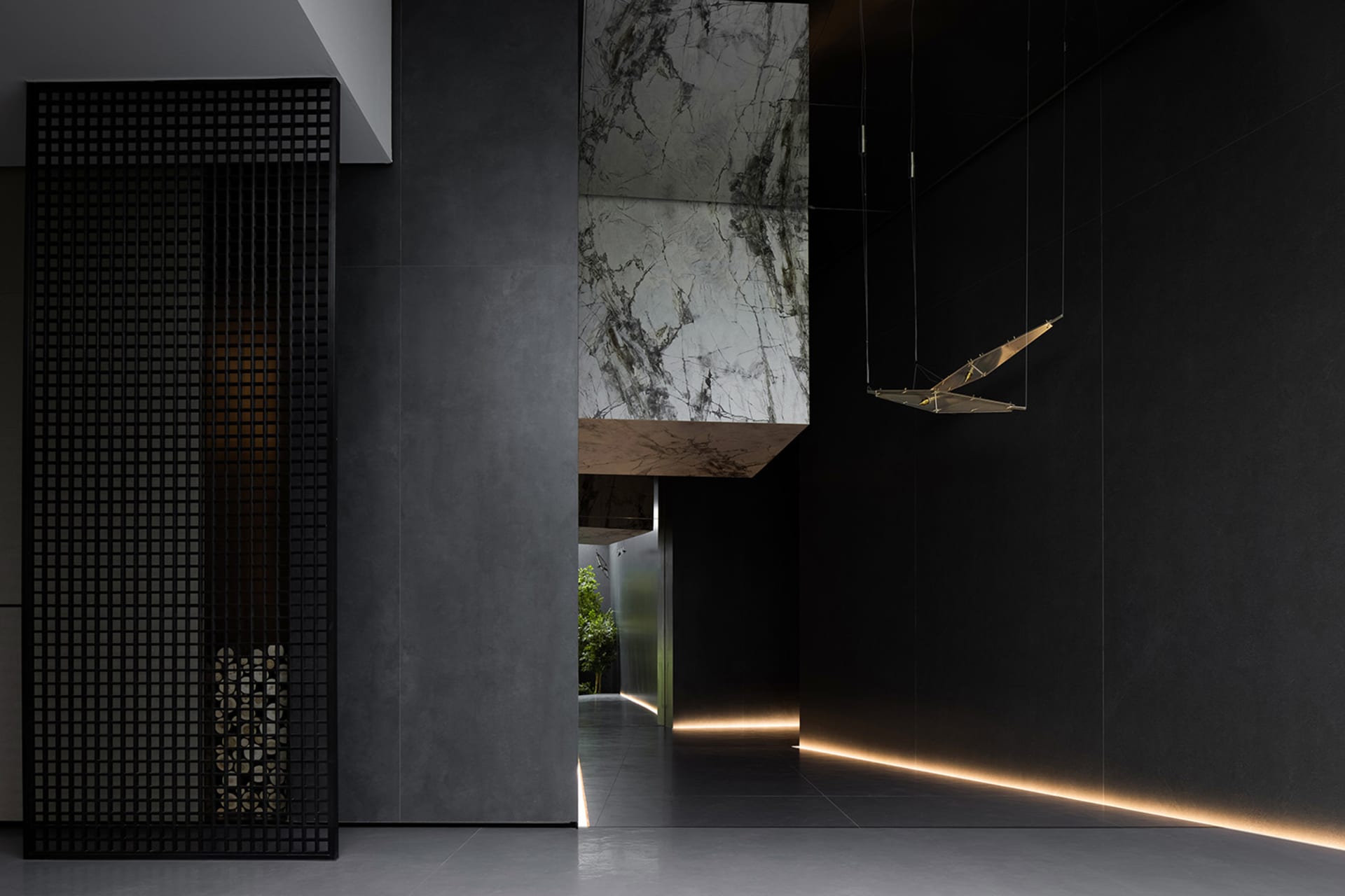 A modern interior design featuring concrete walls with embedded lighting and a minimalist spatial composition.