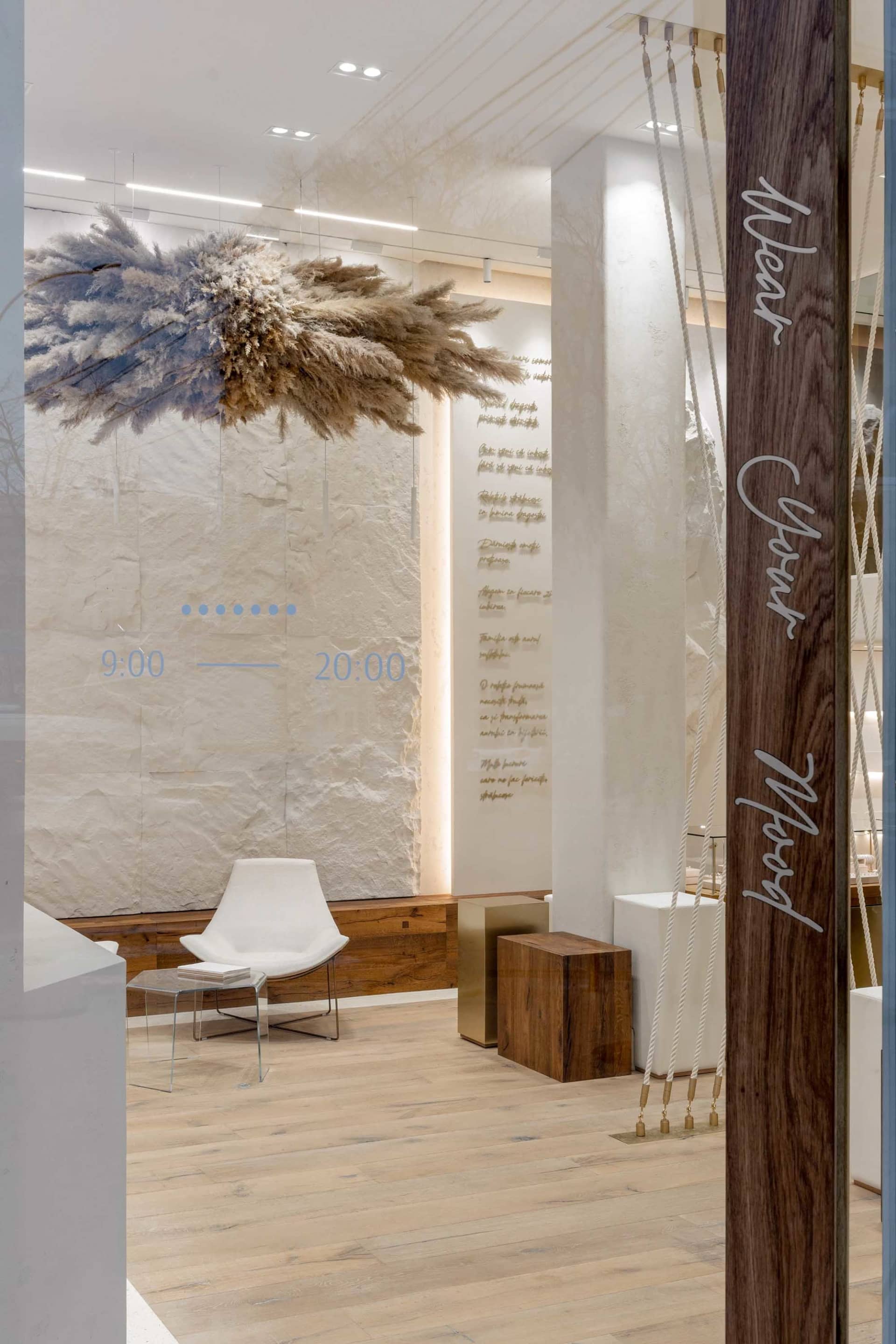 A retail storefront featuring concrete walls and handmade architectural features.