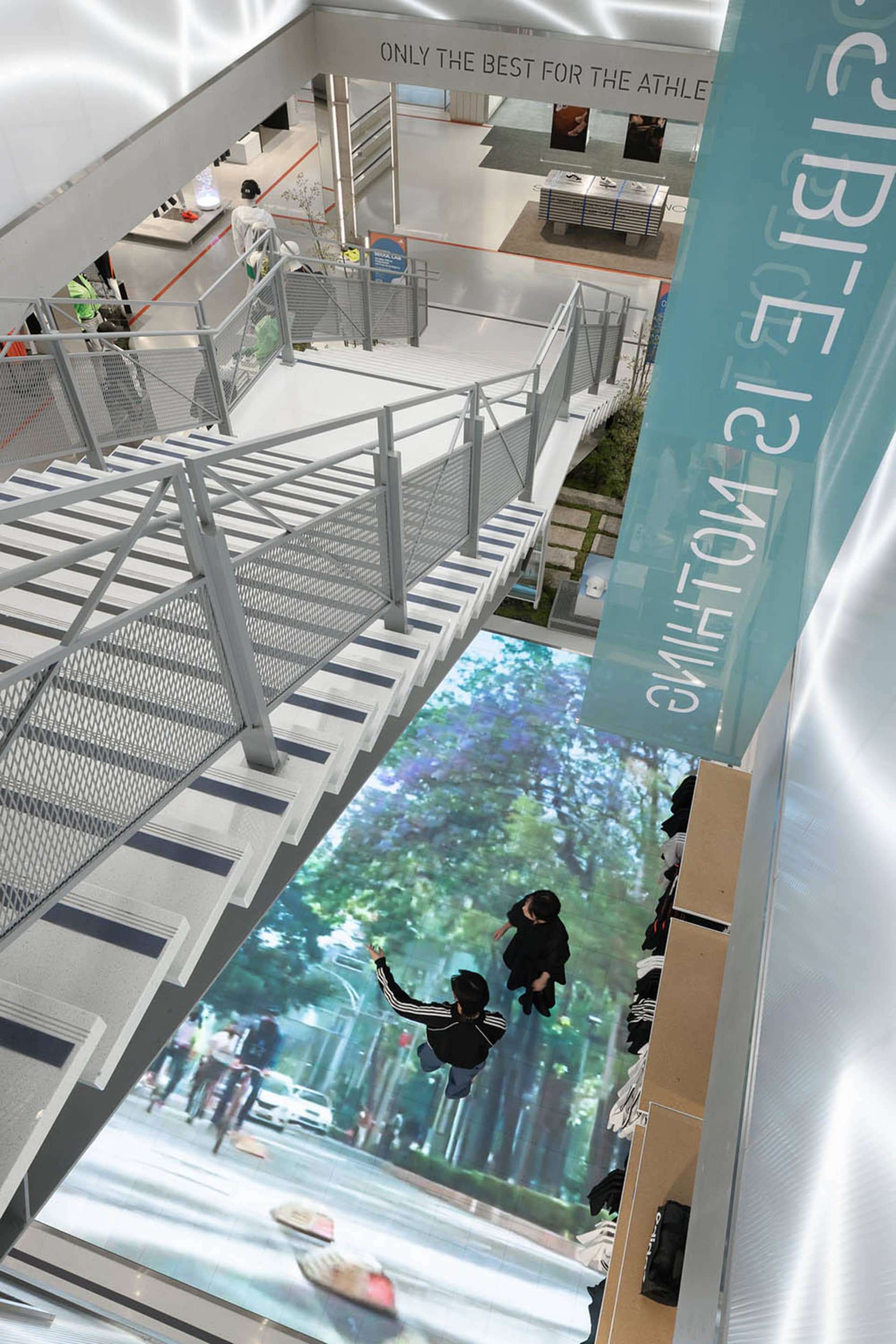 A modern retail space featuring a glass floor overlooking a cityscape.