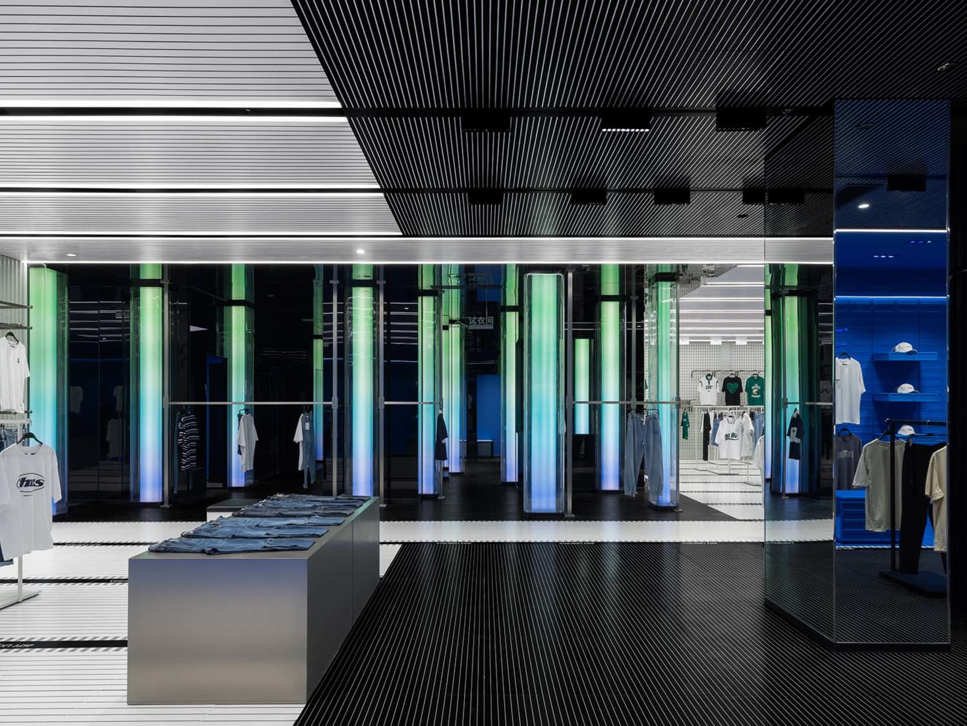 A modern retail store featuring glass walls, metallic accents, and illuminated signage.