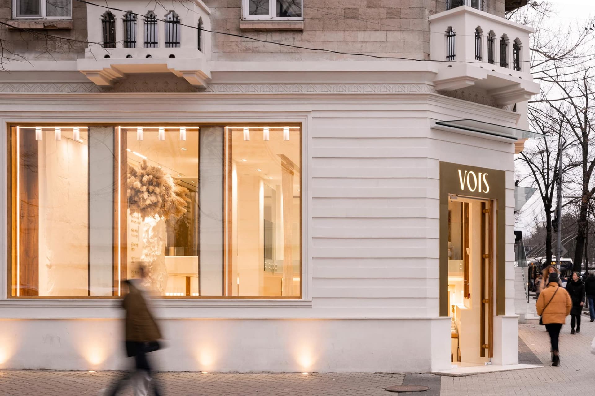 A modern storefront with large glass windows and stone accents.