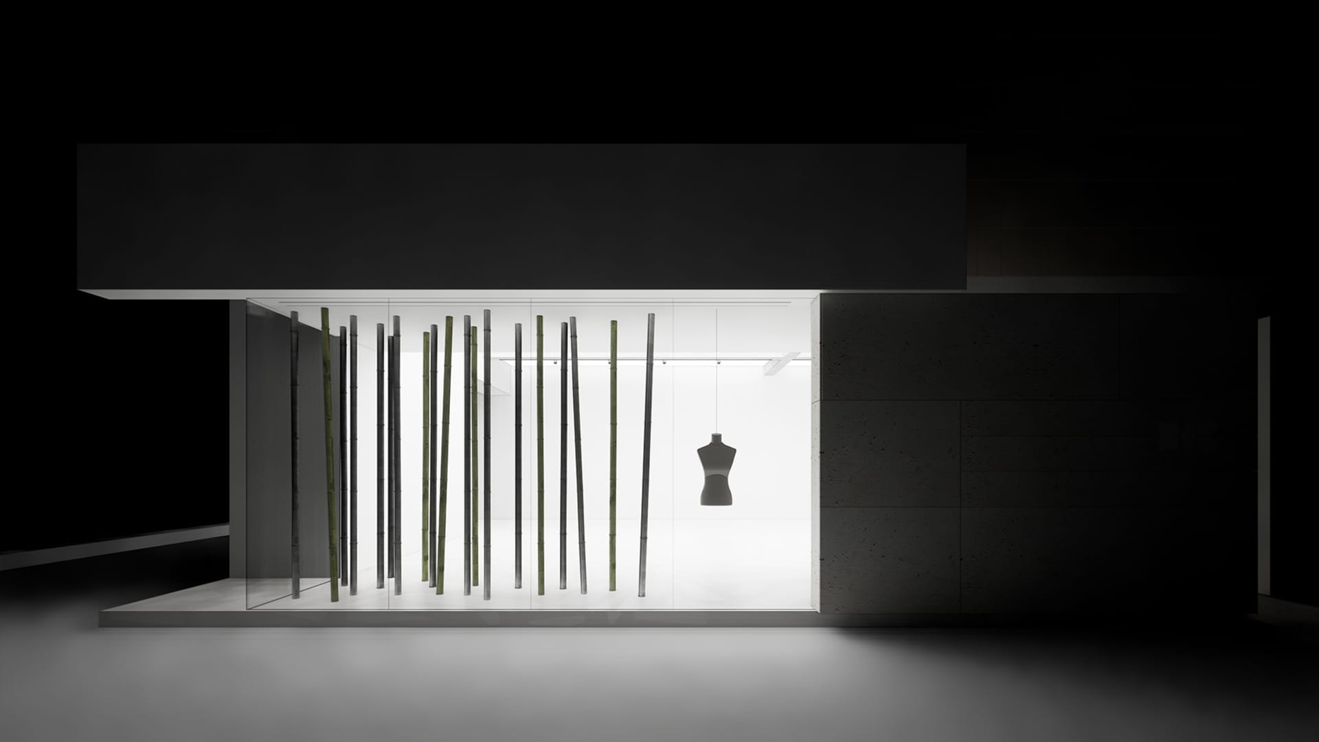 A minimalist exhibition space featuring glass and metal materials.