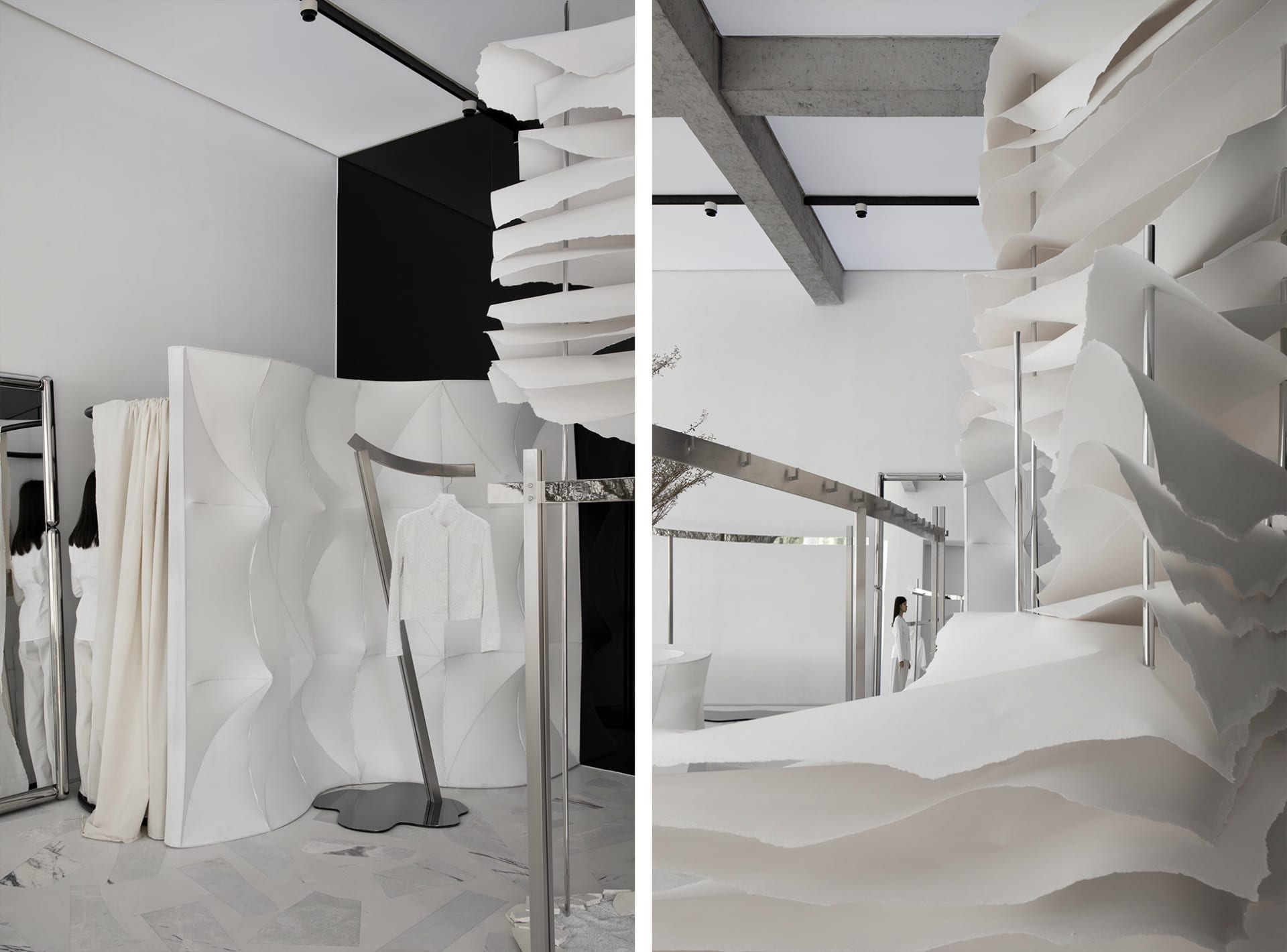 Modern minimalist fashion retail store featuring paper textiles and concrete architectural elements.