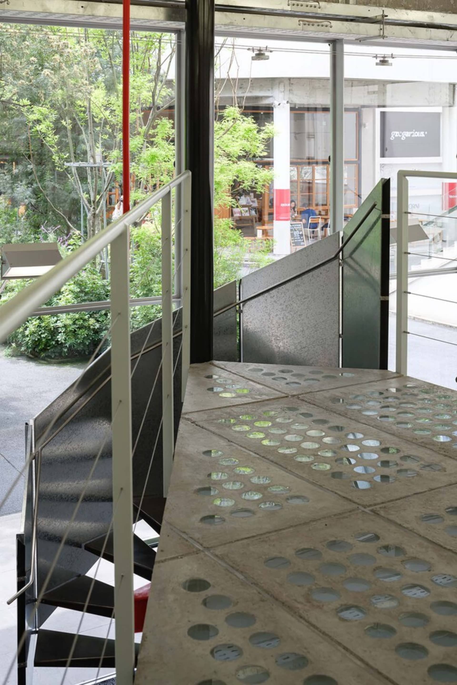 Inside a modern building with concrete floor and stairs