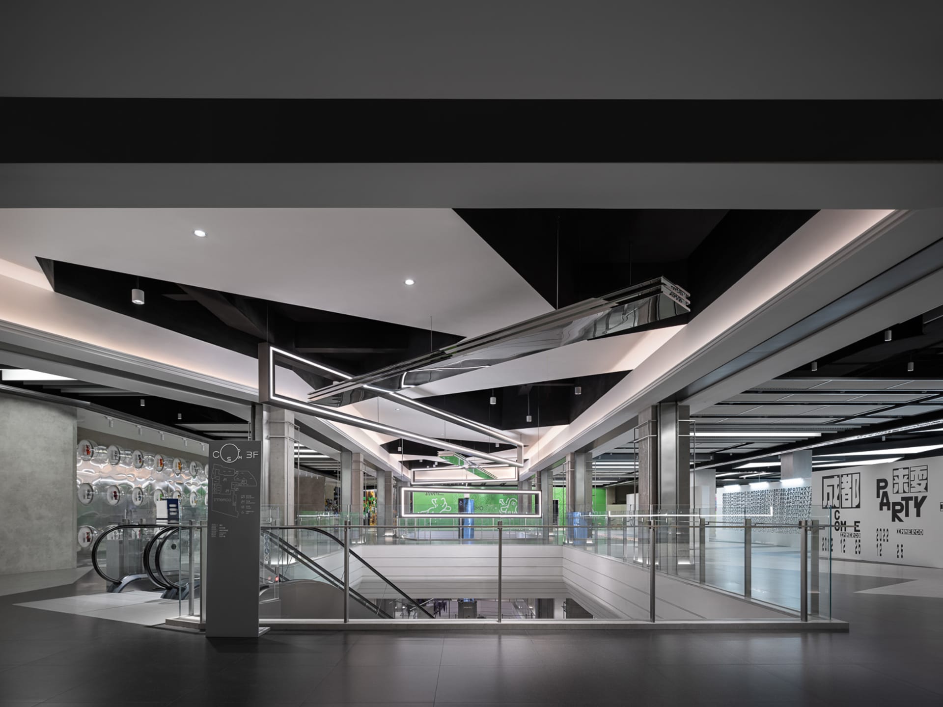 Shopping center interior featuring modern design with glass, metal, and concrete materials.