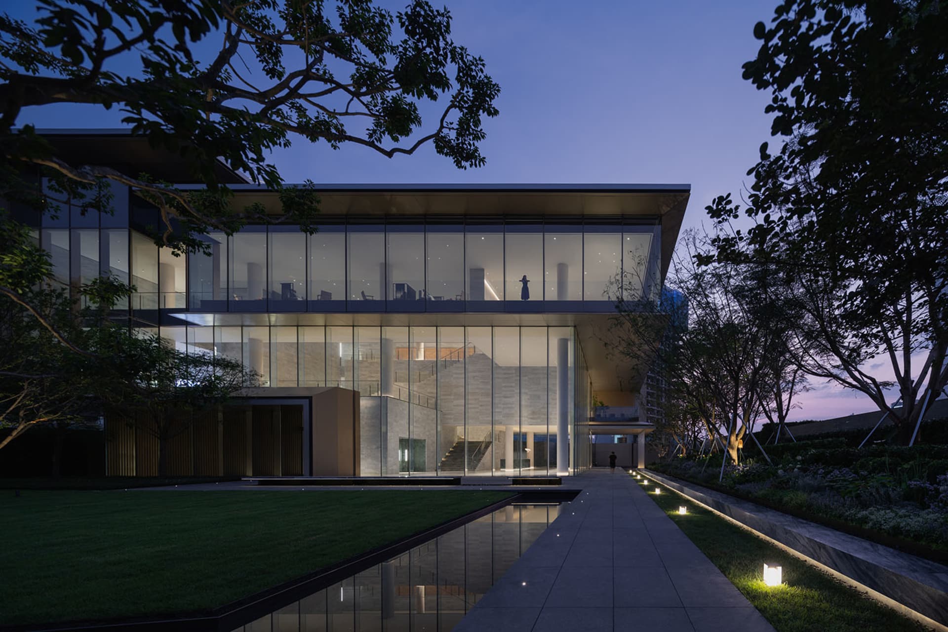Modern building with glass and concrete exterior at dusk