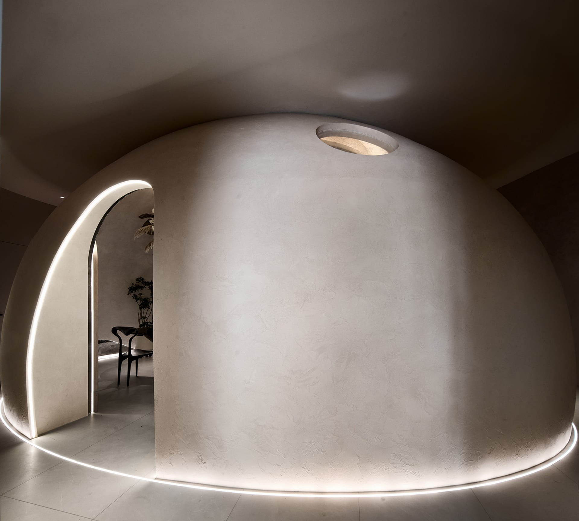 A modern living room with a concrete wall and floor, featuring minimalistic design elements.