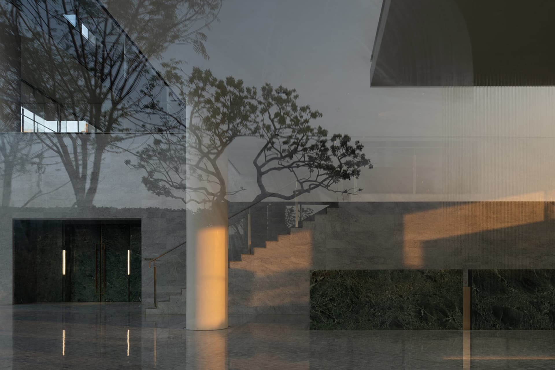 Modern lobby interior featuring concrete walls and marble floor.