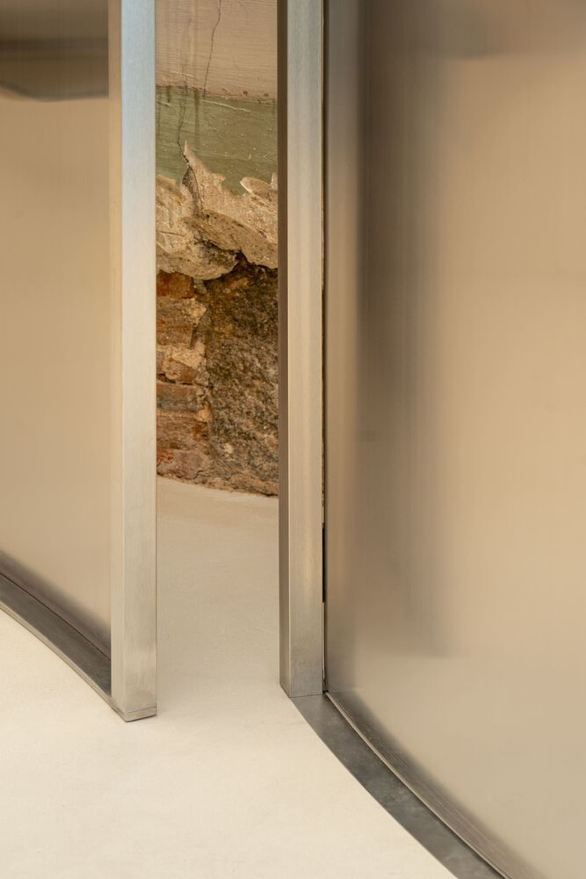 A modern interior space featuring a glass wall, showcasing contemporary design.