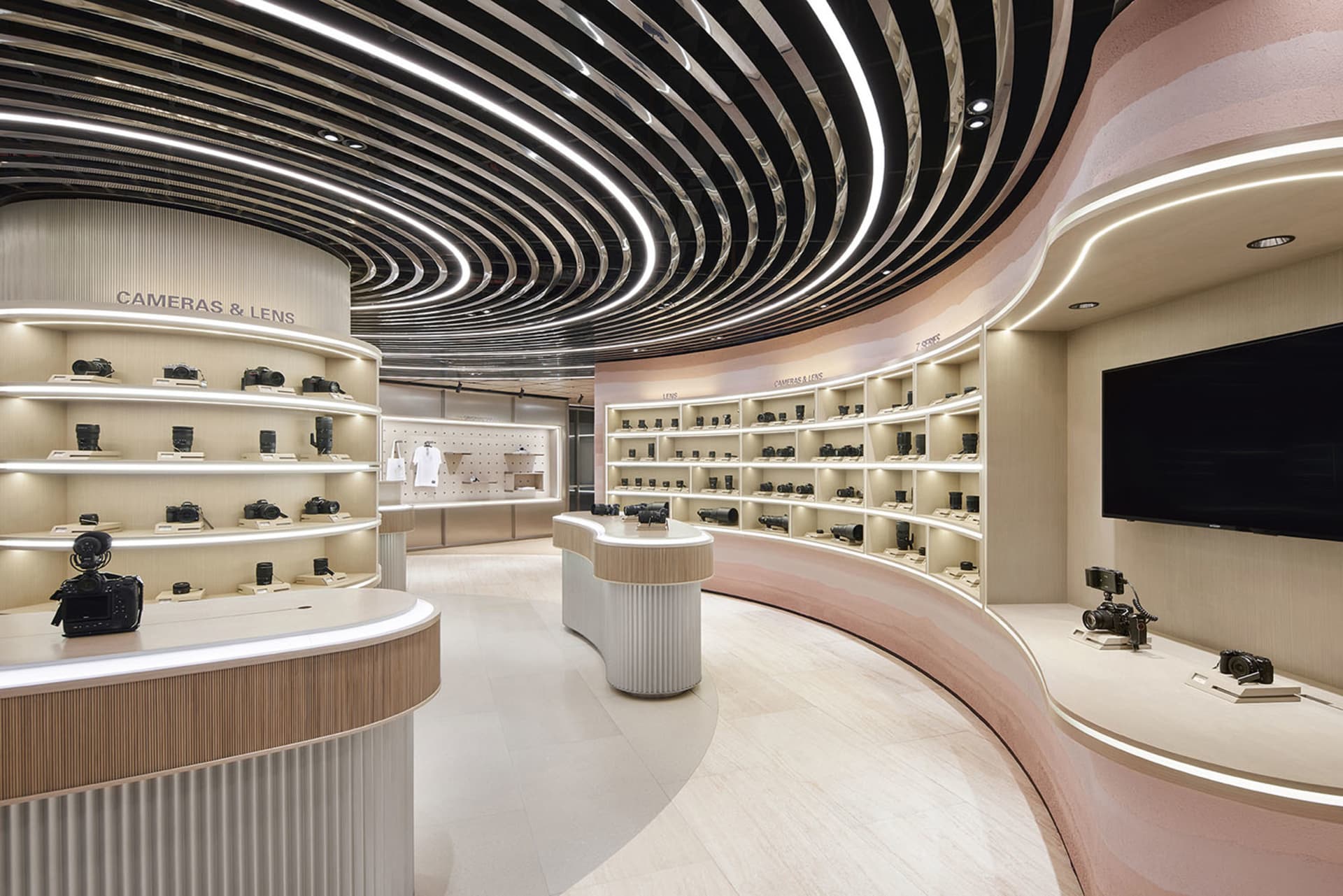Modern camera store featuring light wood, concrete, and curved panels