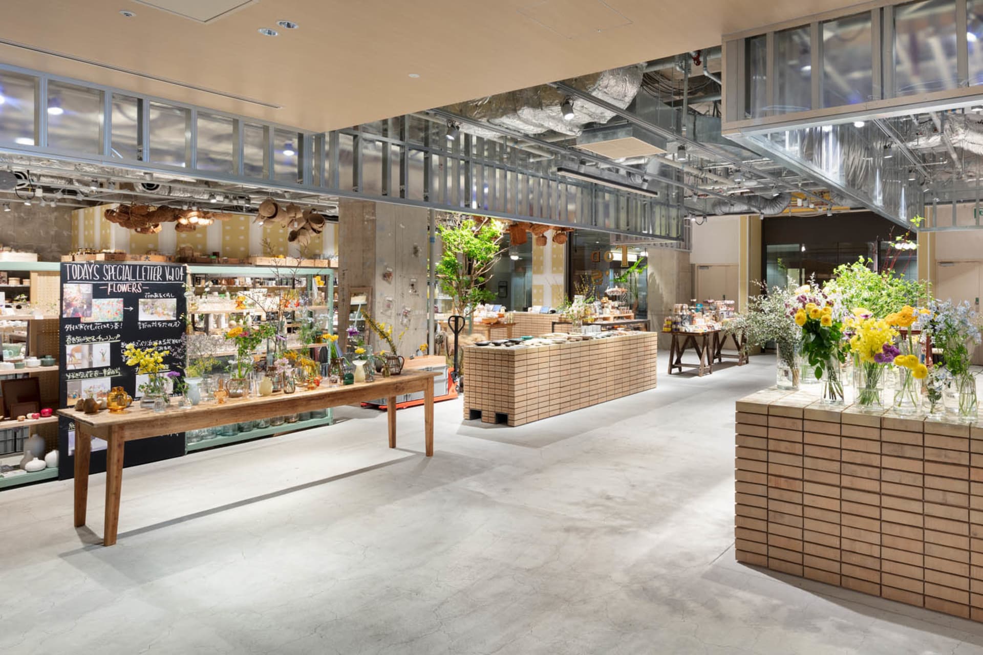 A modern floral shop with wooden decor and potted plants.