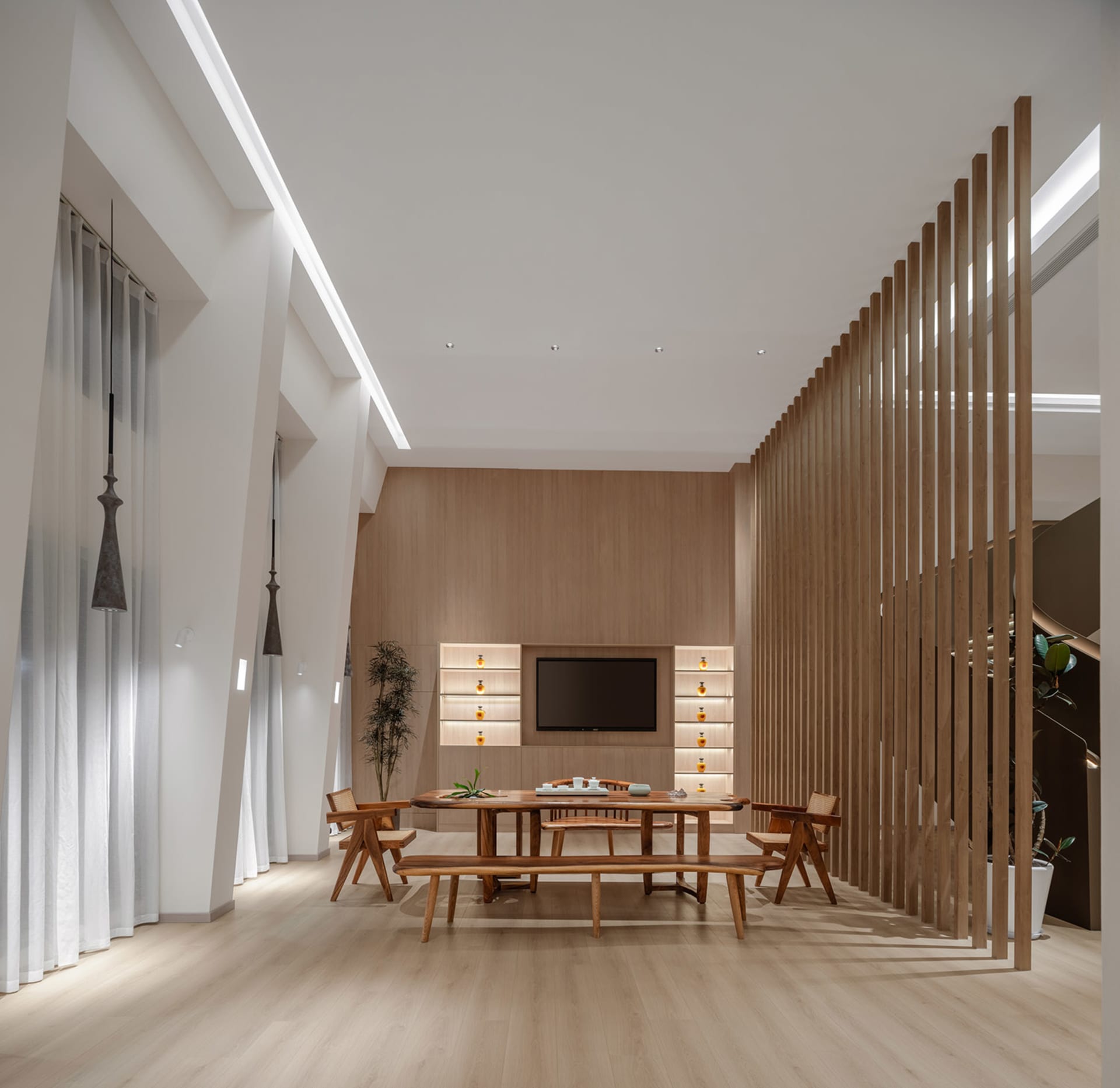 Modern minimalist living room with wood furniture and white walls.