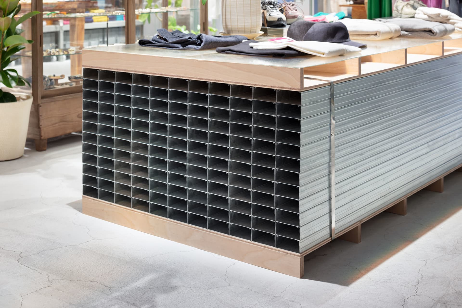 A modern retail display featuring a metal grid structure and industrial finishes, showcasing organized and structured present