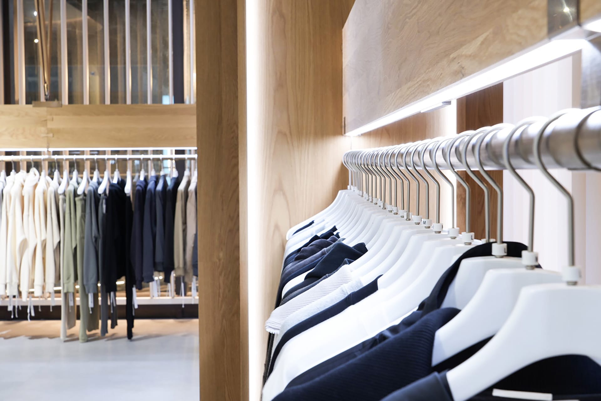 Clothing store interior with wooden displays and metal racks