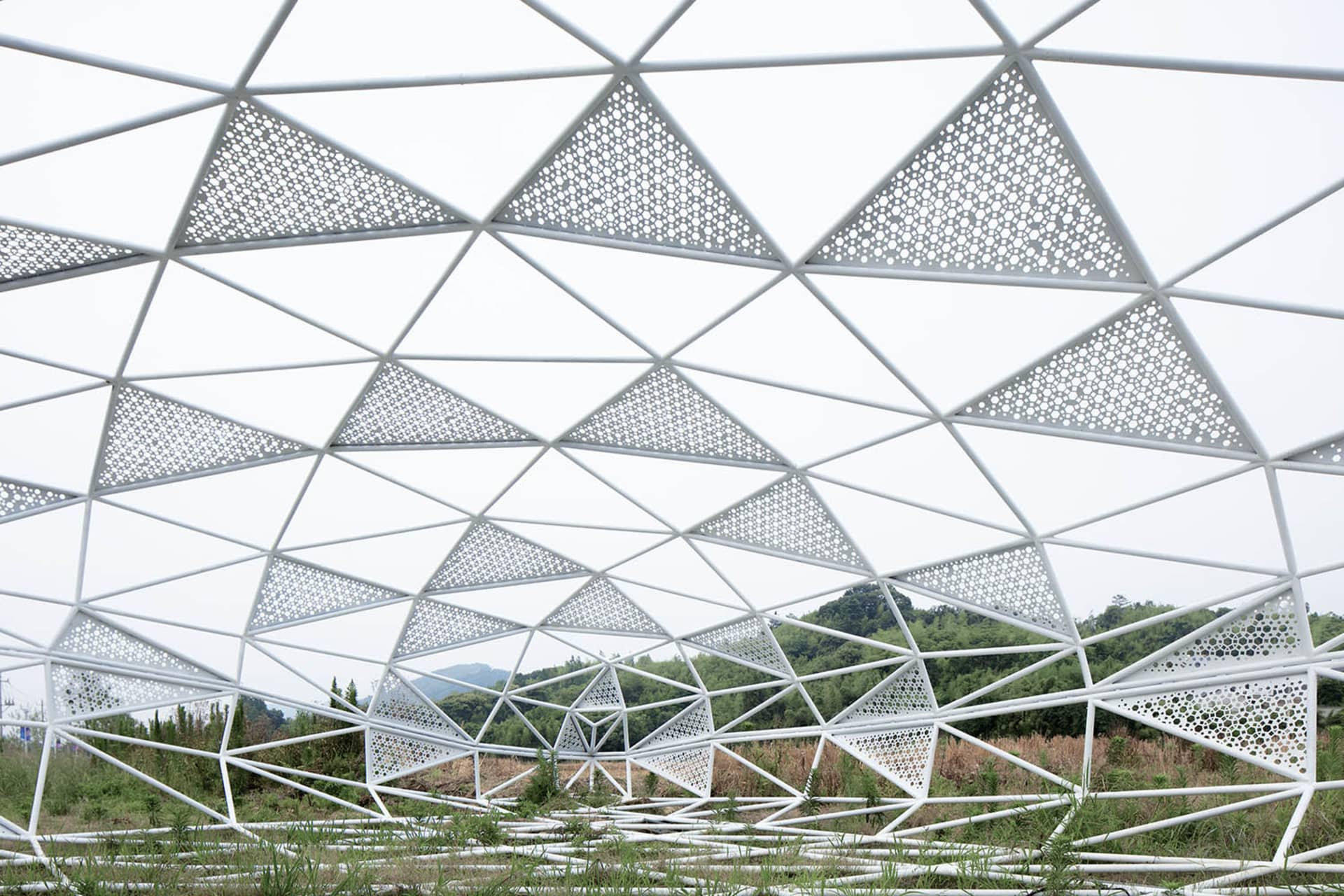A large, white metal structure with a triangular pattern.