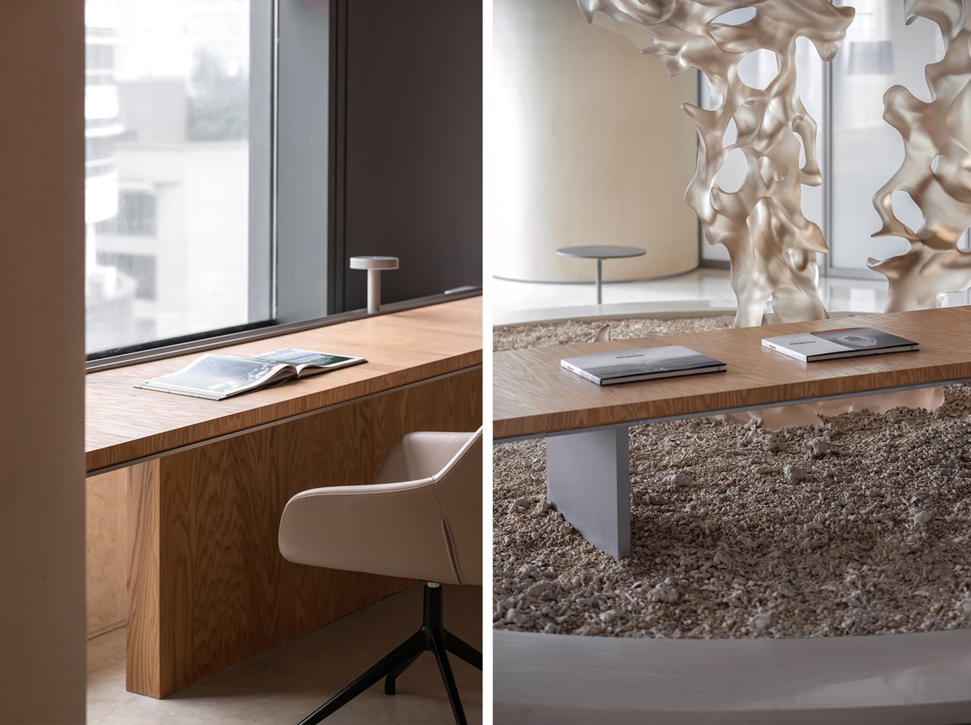 An empty conference room in an office building, featuring a wooden bench, a modern chair, and an artistic sculpture on the ta