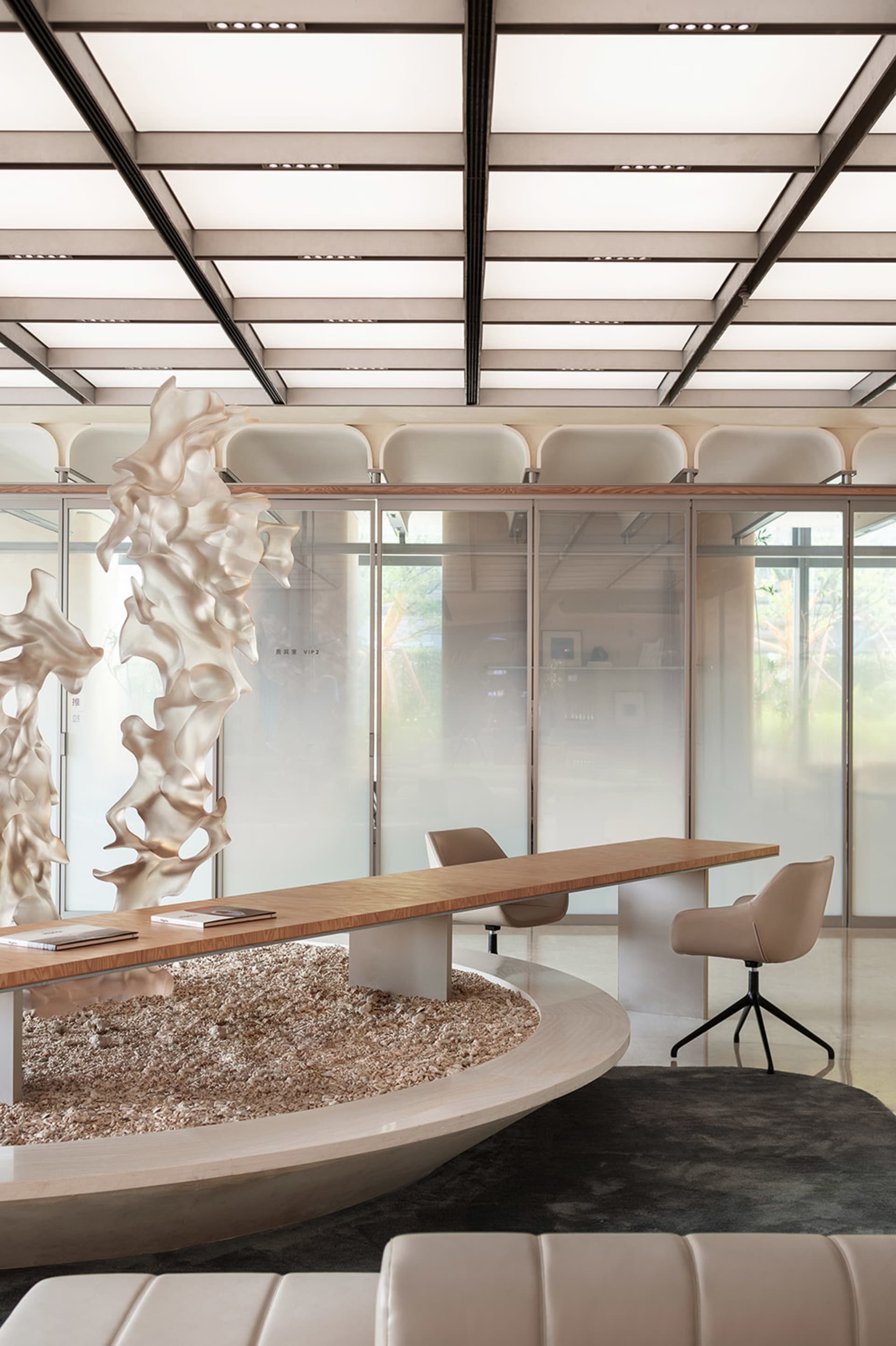 A modern office space with glass partitions and minimalist furniture.