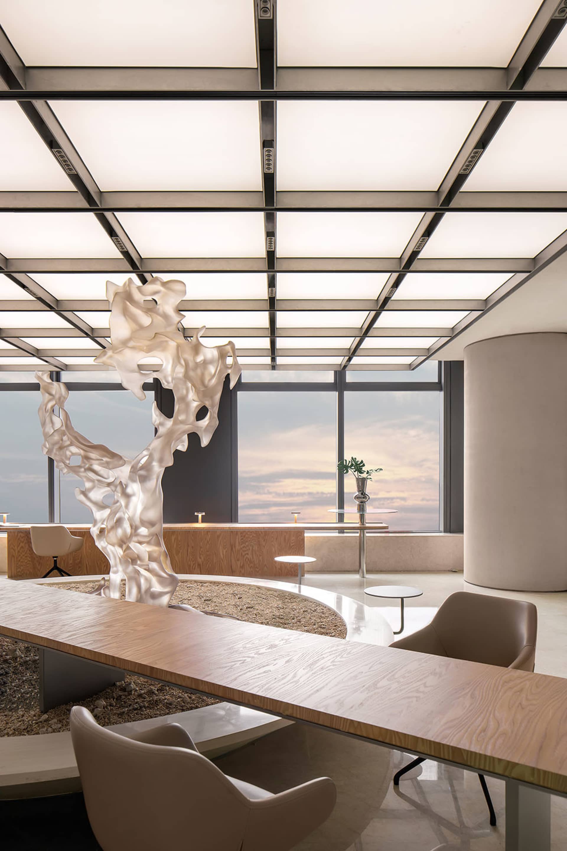 Modern office space featuring a metallic sculpture with a minimalist design.
