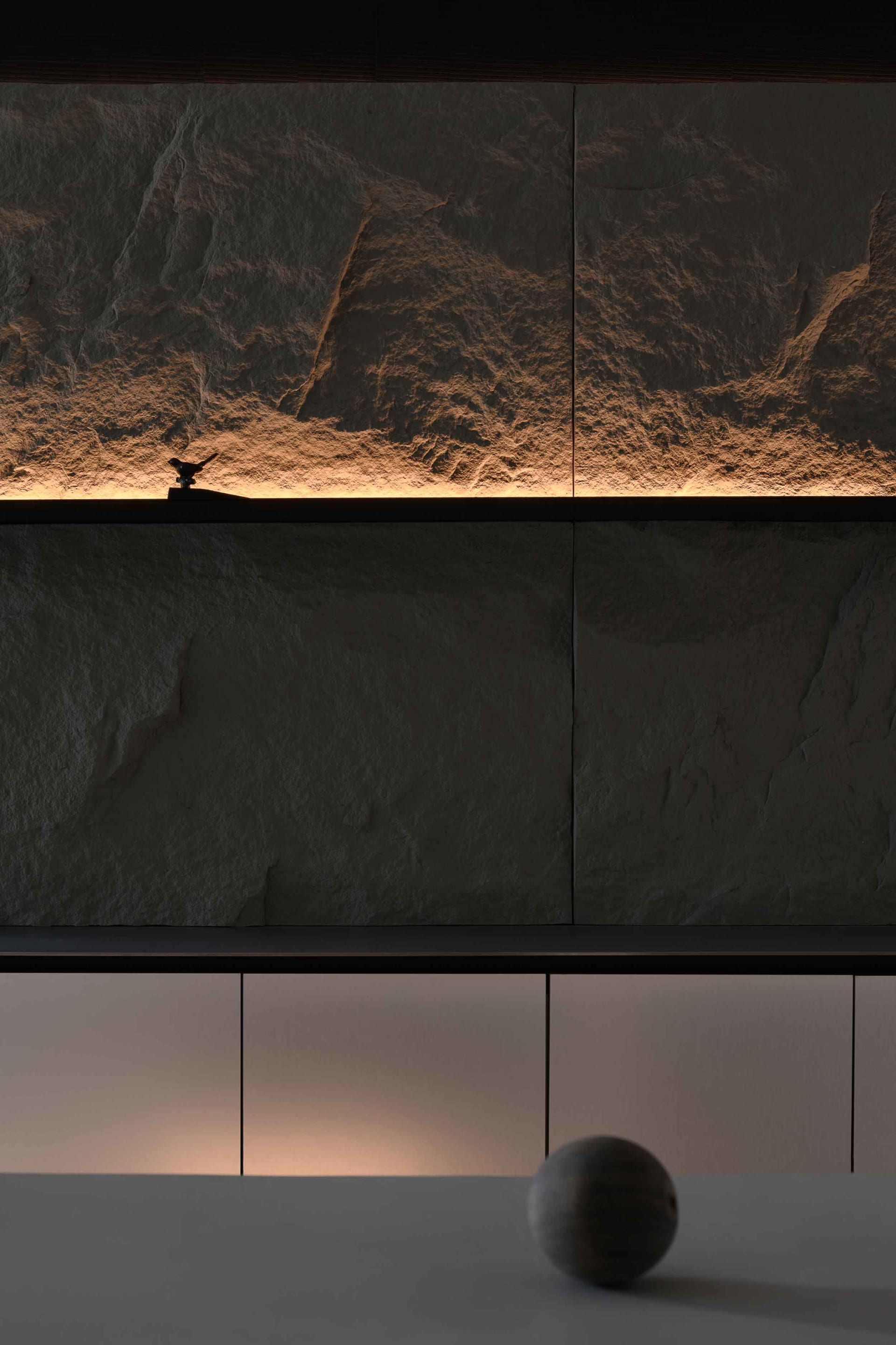 Modern residential interior with stone features and lighting