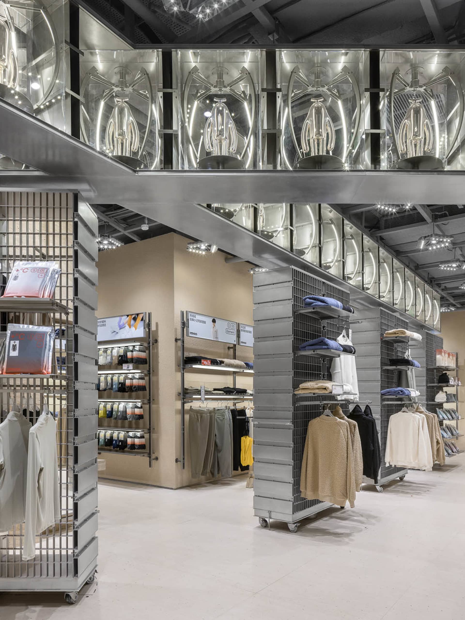 Interior view of a modern retail clothing store with metal and glass features.