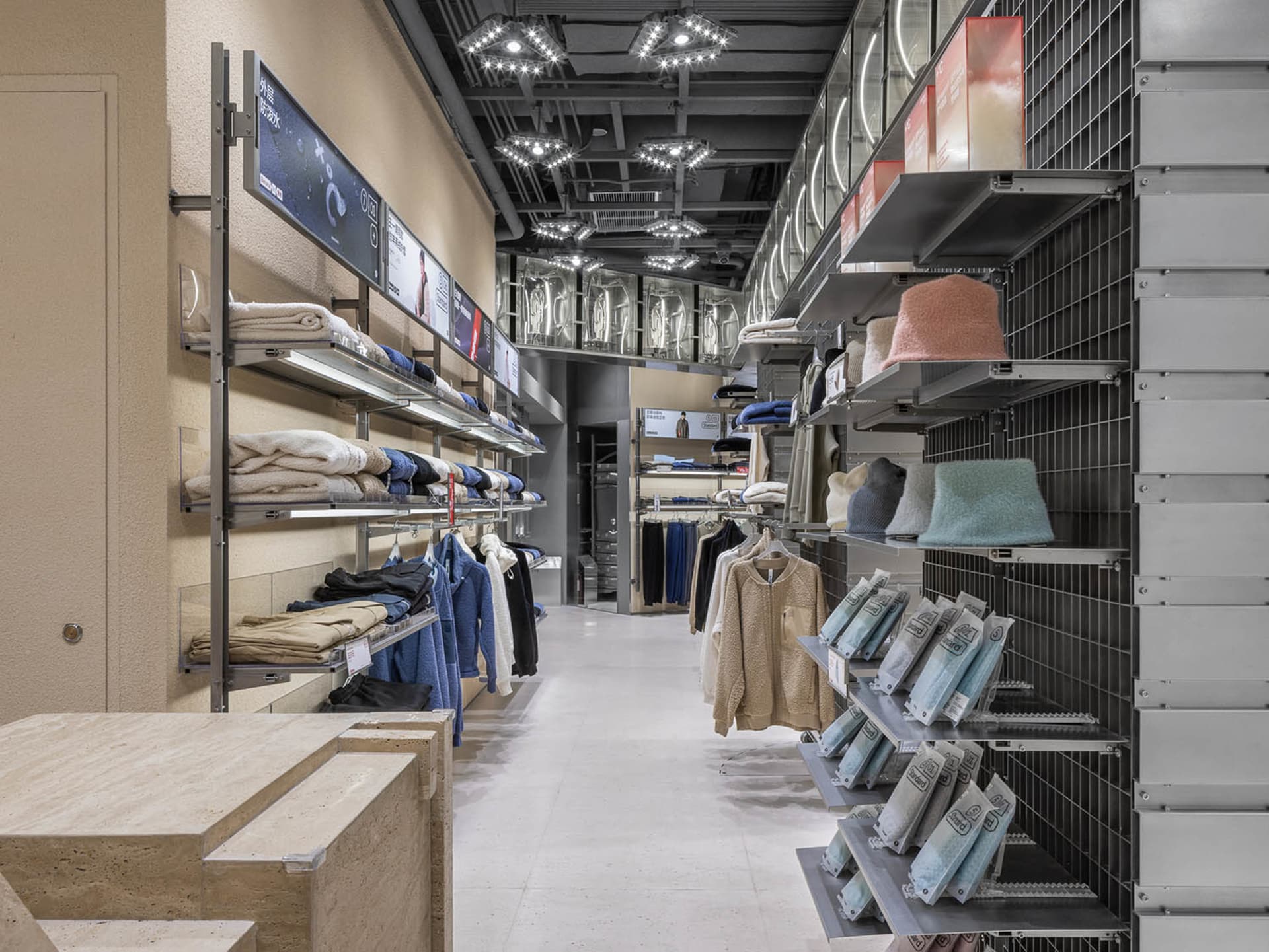 Modern retail store interior with clothing racks and shelves.