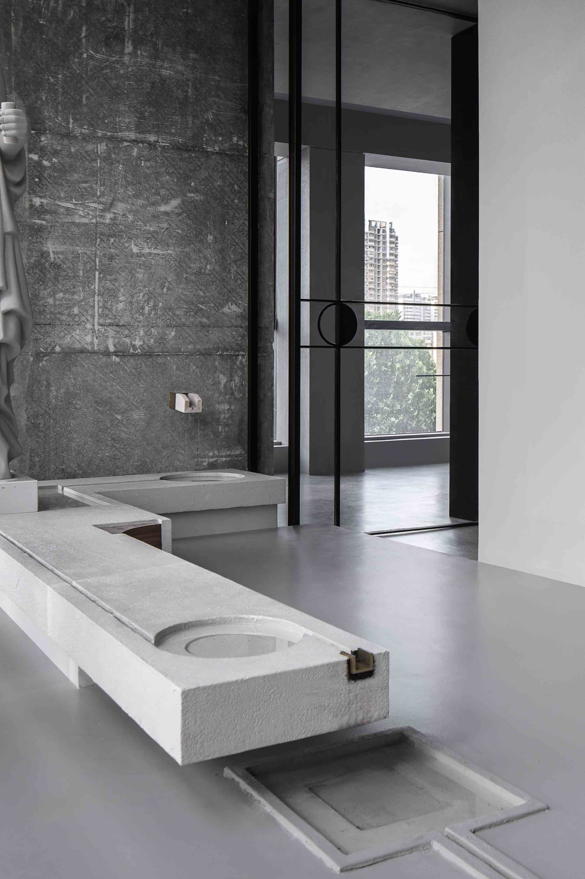 Minimalist bathroom with concrete sink and wall, industrial-style decor.