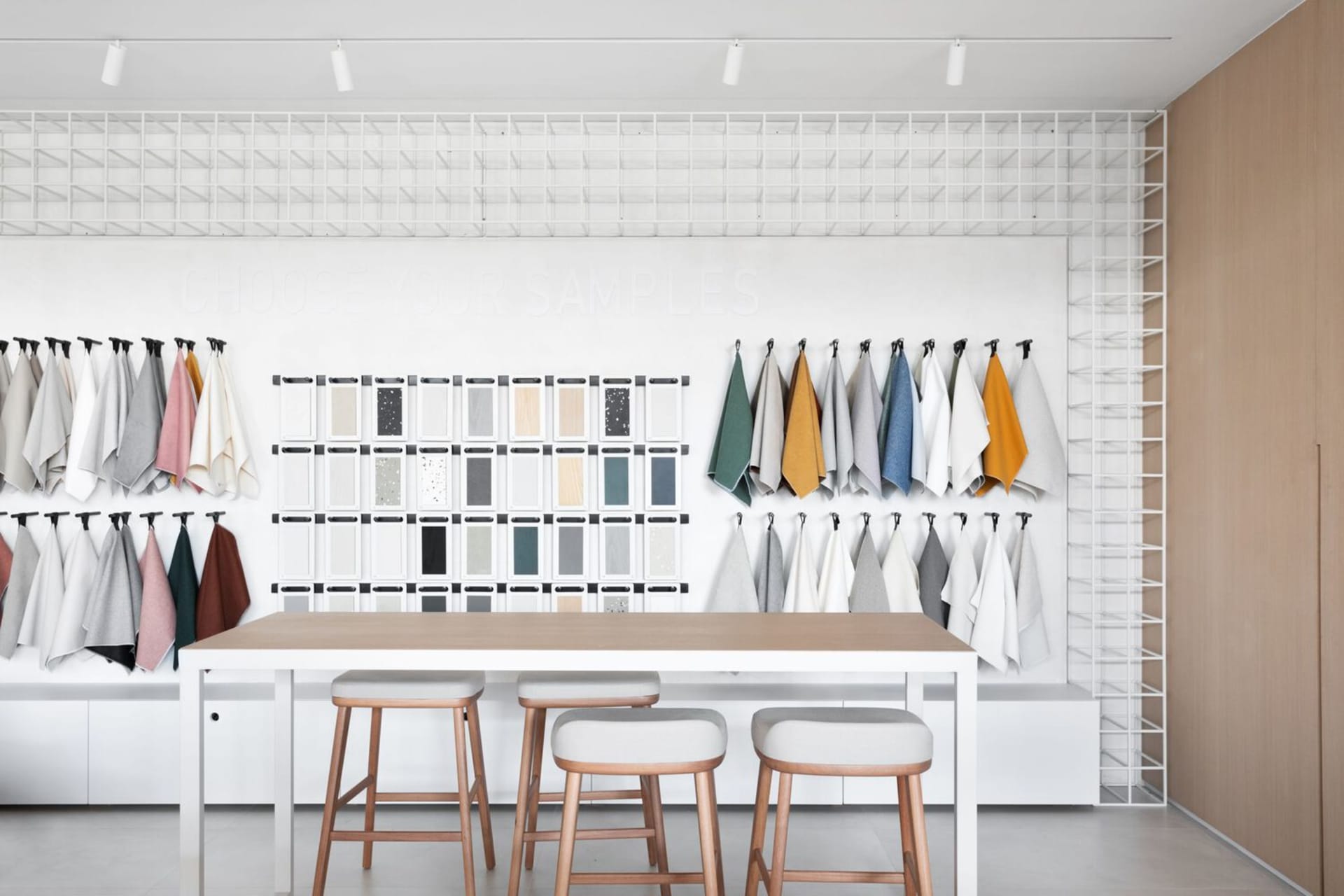 A display of various fabrics and materials in a modern retail setting