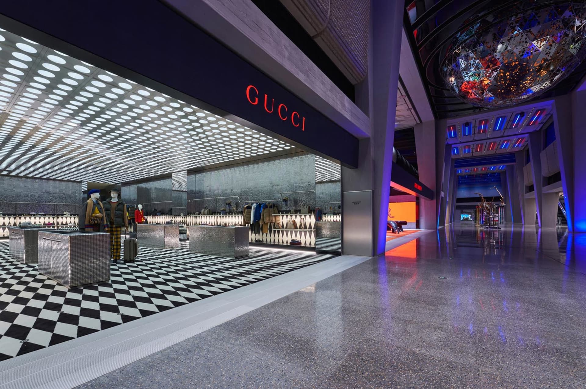 Modern retail storefront with geometric design and glass and concrete materials.