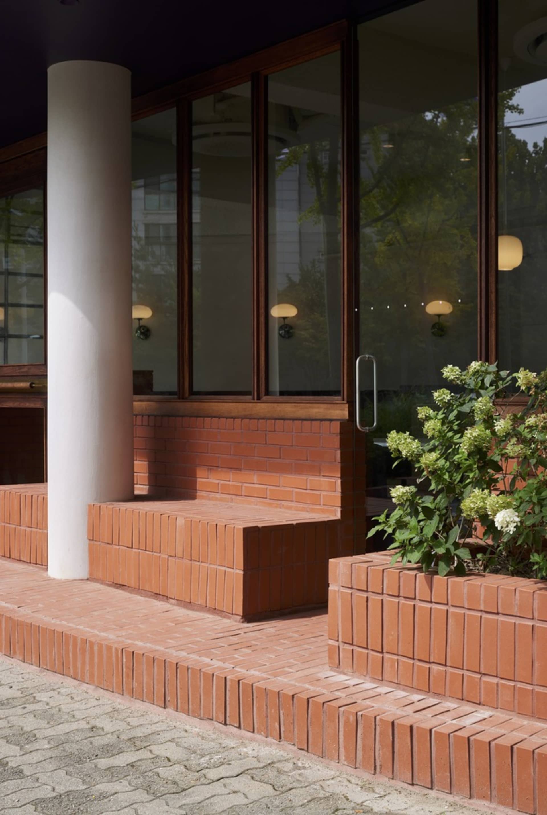 Modern storefront with brick facade and glass doors.